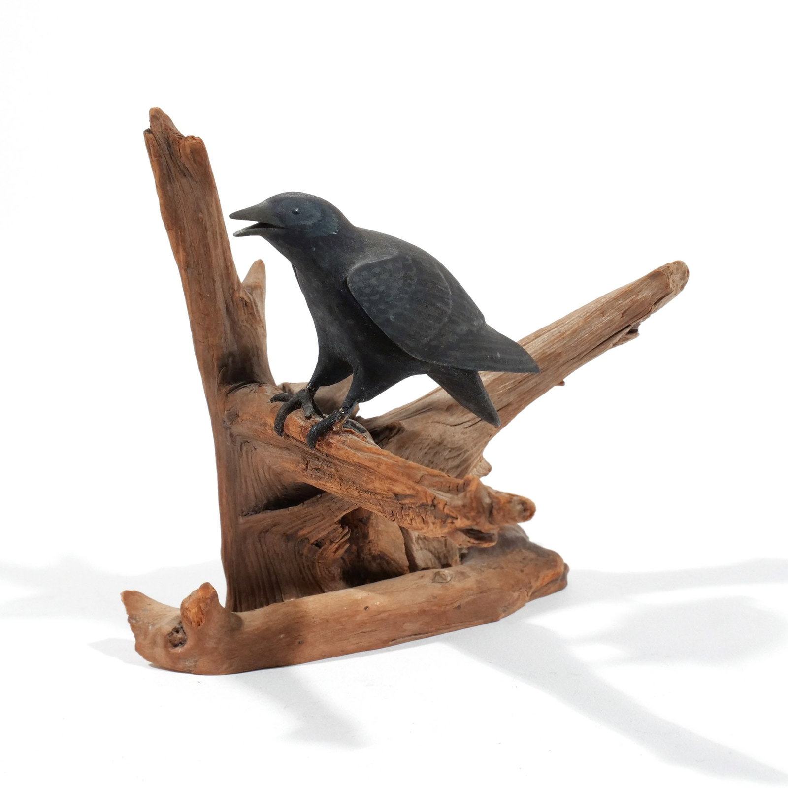 HAROLD GIBBS (1886-1970) AMERICAN CROW: Carved miniature, perched on a driftwood base, signed with conjoined 'HNG' on underside h. 4-1/4 w. 4-3/4 d. 4 in. (overall) Provenance: Descended through the estate of U.S. Ambassador James C. H. Bon