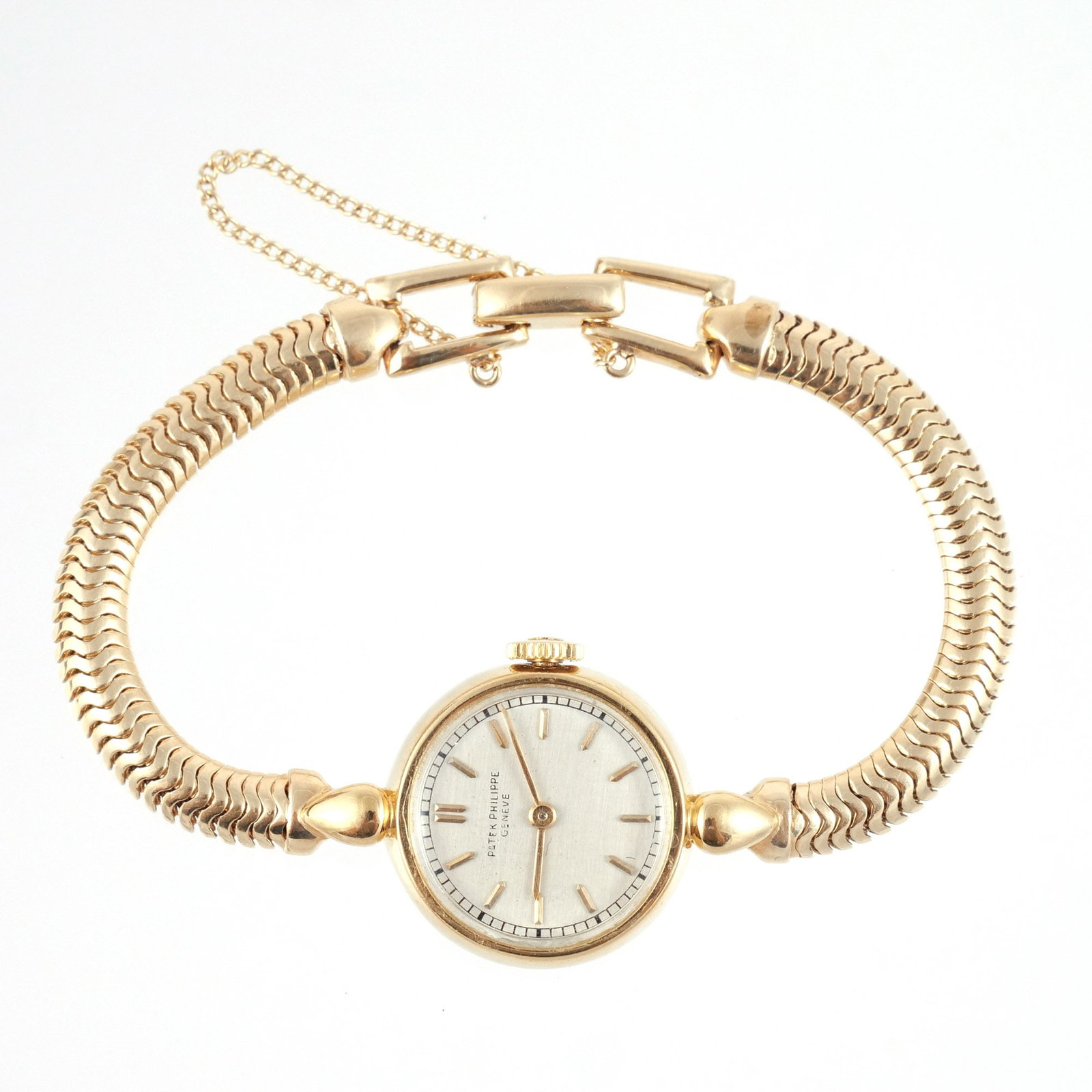 PATEK PHILIPPE 18K GOLD LADY'S WATCH: Reference 1111 model, c. 1940s, mounted on a 14k herringbone-link bracelet with fineness mark and maker's mark 'C+B'; interior case marked '0.750', signed 'Patek Philippe & Co. / Geneve / Swiss / Ref 