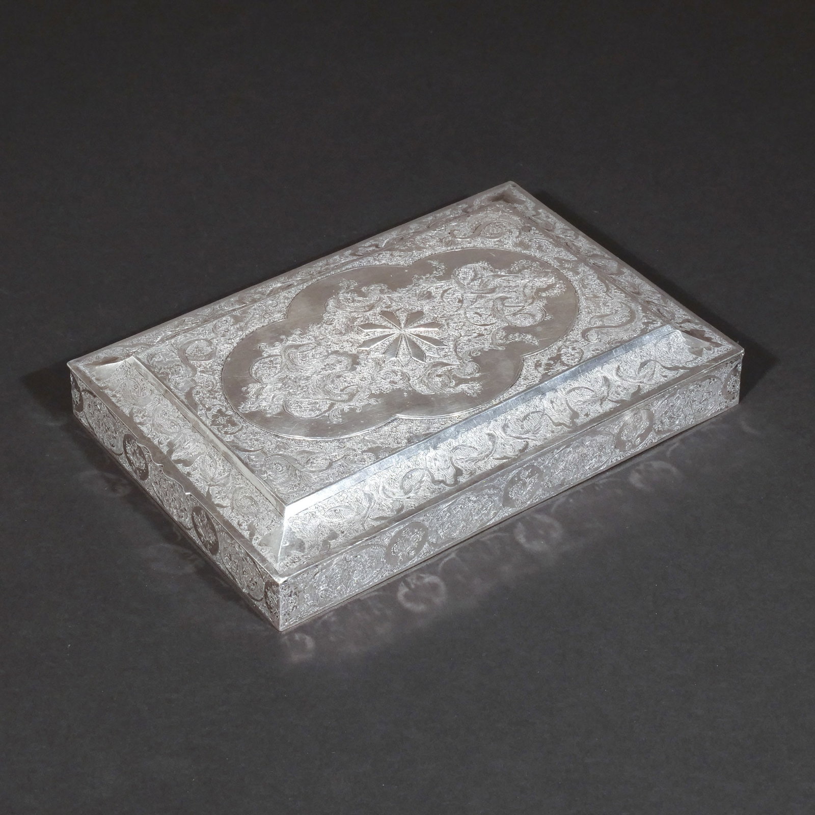 PERSIAN (IRANIAN) SILVER TABLE BOX: Early 20th century, '84' silver engraved on the top and sides with pairs of pheasants among foliage and scrolling foliage, the center with raised star device, with Iranian hallmarks, 32 ozt h. 9-1/2 w