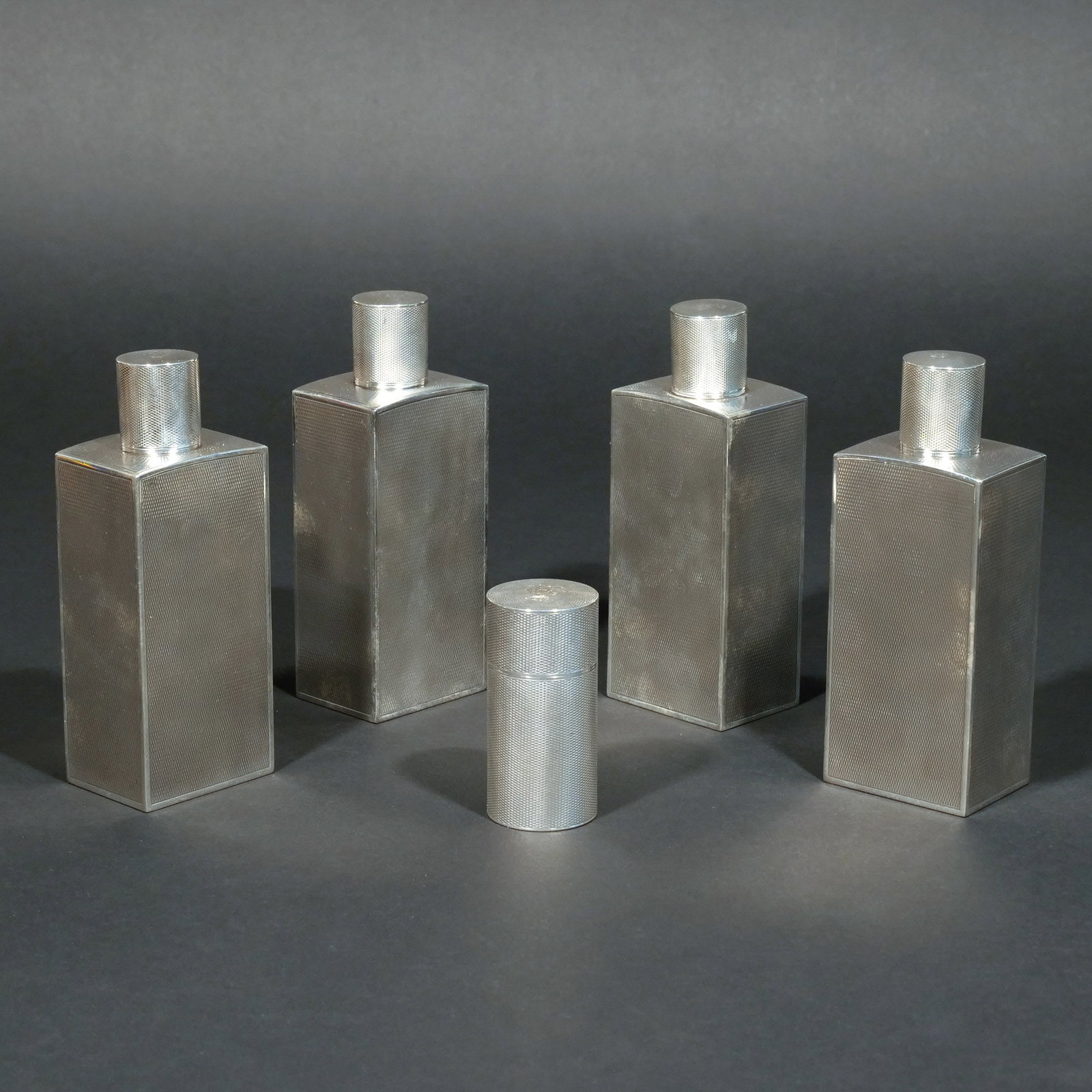 (5pc) .950 FRENCH SILVER VANITY SET: Including 4 silver bottles and a toothpick case, engine-turned silver with French hallmarks, 26 ozt total weight h. 5-1/2 w. 2-1/8 d. 1-1/2 in. (largest) Provenance: Descent through the consignor's fa