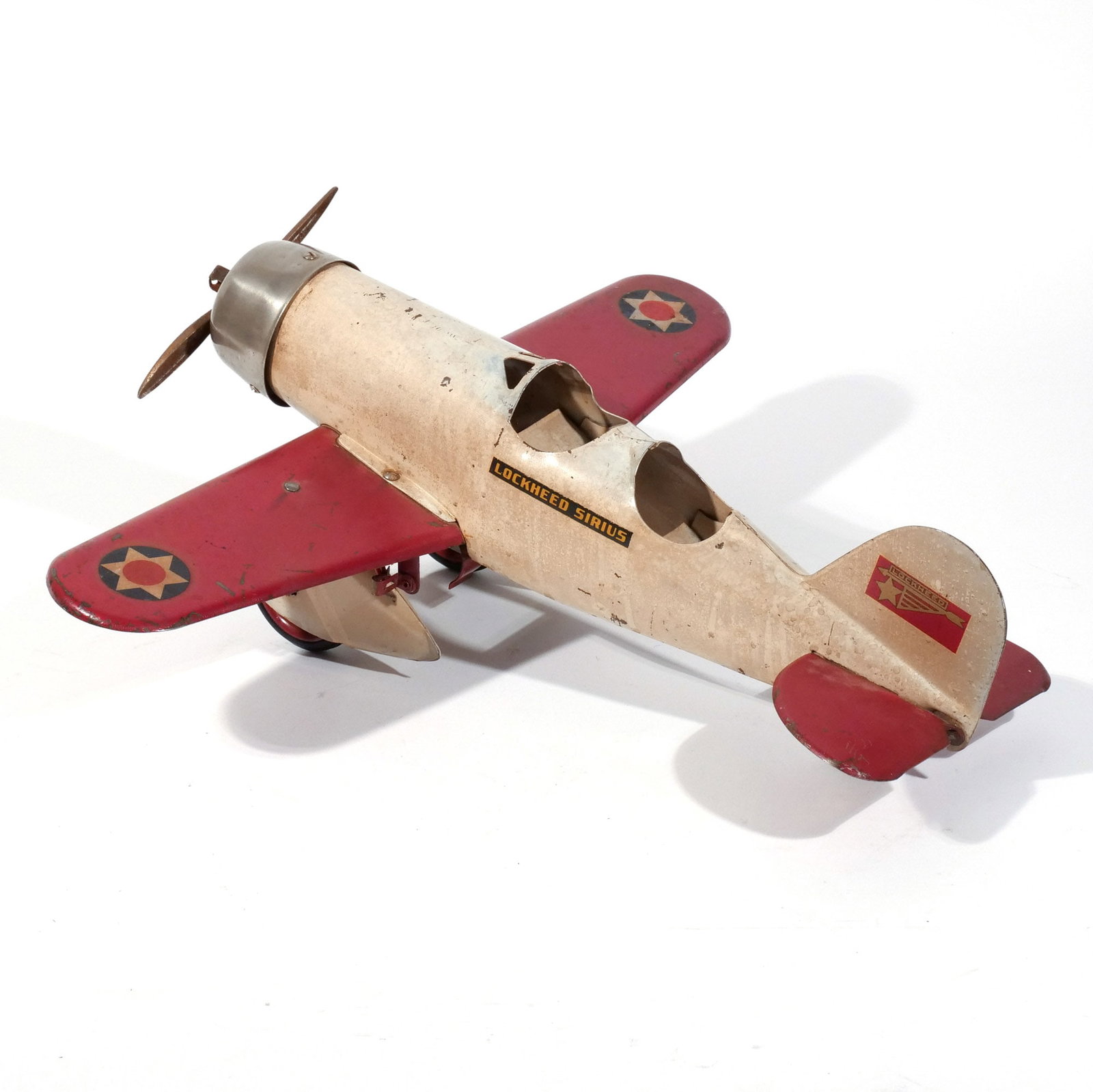STEELCRAFT LOCKHEED SIRIOS METAL TOY PLANE: c. 1930s, in white and red paint h. 8 w. 22 d. 22 in. Provenance: Private collection, Bernardsville, NJ [In Situ Item] This item will not be on display in our saleroom during our preview period. If