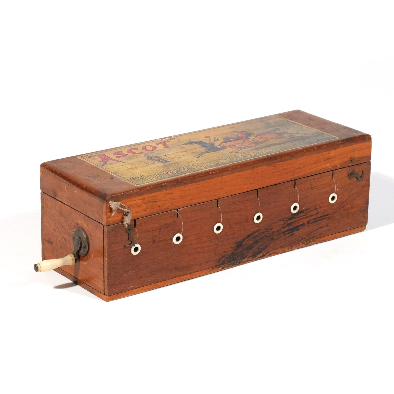 ASCOT' RACING GAME BOX: John Jaques & Son Ltd, Ascot "The New Racing Game", London, circa 1900, rectangular wood box with bone crank and six cast lead horses with riders attached to strings, top of the box with its original