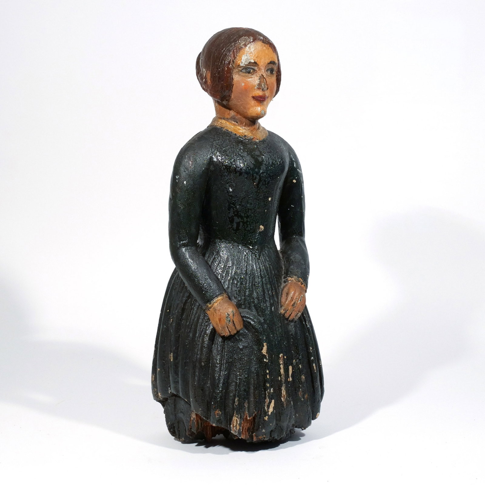 CARVED POLYCHROME YACHT'S FIGUREHEAD: 19th century, carved wood and painted in the form of a young woman holding a fan, appears to retain old polychrome surface h. 23 w. 10 d. 8 in. Provenance: Eldred's auction, East Dennis, MA, 15 Oct.,