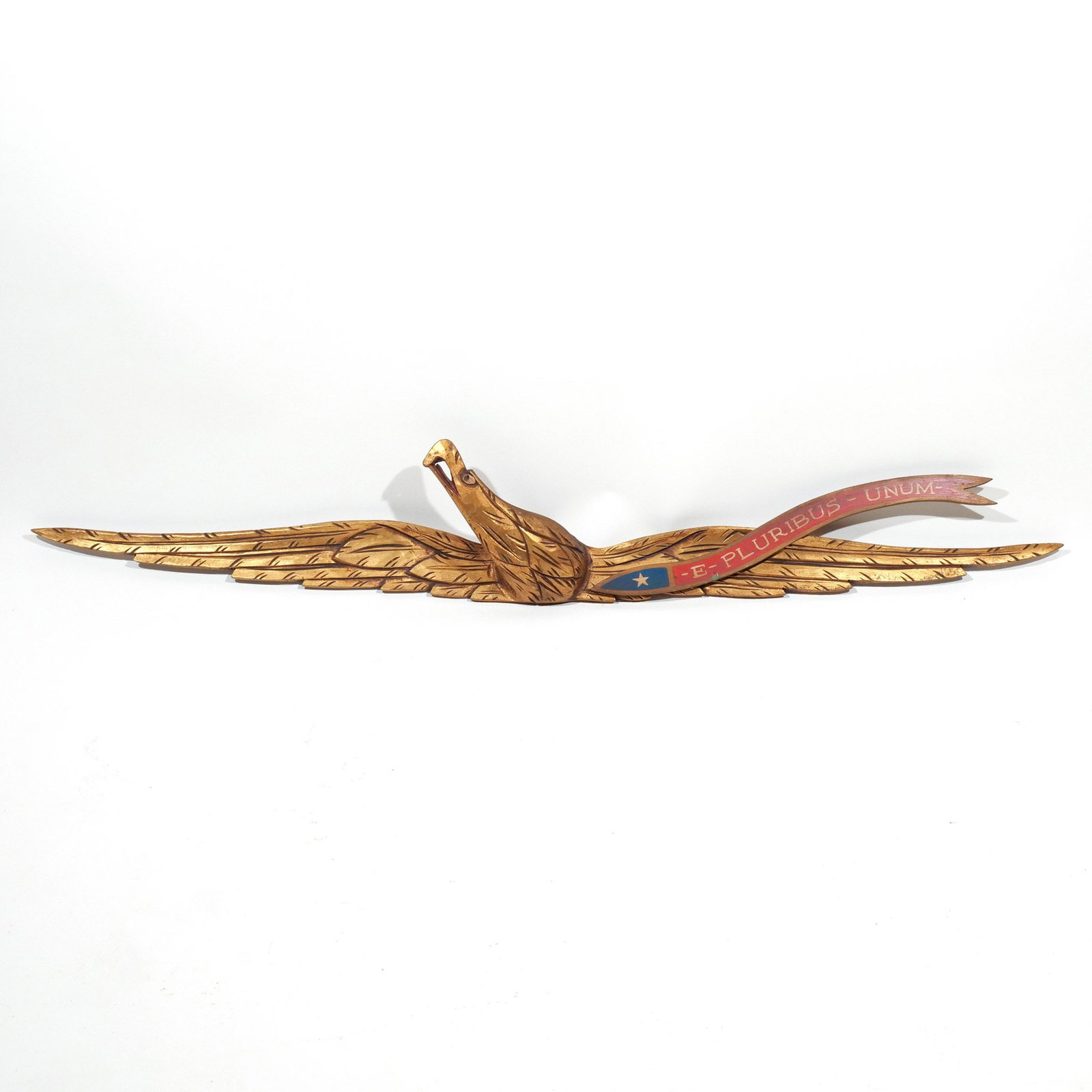CARVED POLYCHROMED AMERICAN EAGLE PLAQUE: Early 20th century, in the style of John Haley Bellamy, banner reading '- E - Pluribus - Unum -' ('Out of many, one') h. 7-1/2 w. 44 in. Provenance: Private collection, Bernardsville, NJ