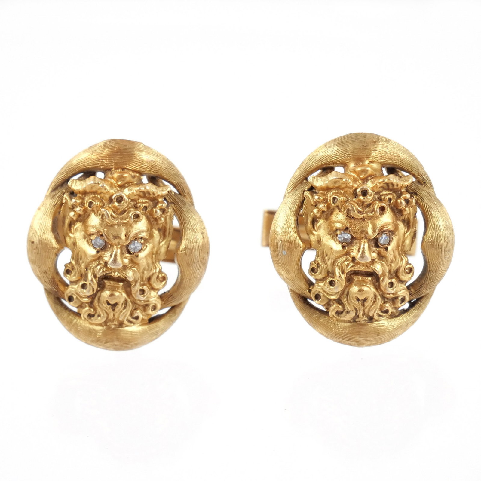 PAIR of 14K GOLD SATYR CUFFLINKS: Hammered surround with melee diamond eyes, signed 'Wallach' and marked '14k', 25.8 g total weight h. 1 w. 7/8 in. Provenance: Descended through the estate of U.S. Ambassador James C. H. Bonbright, Was