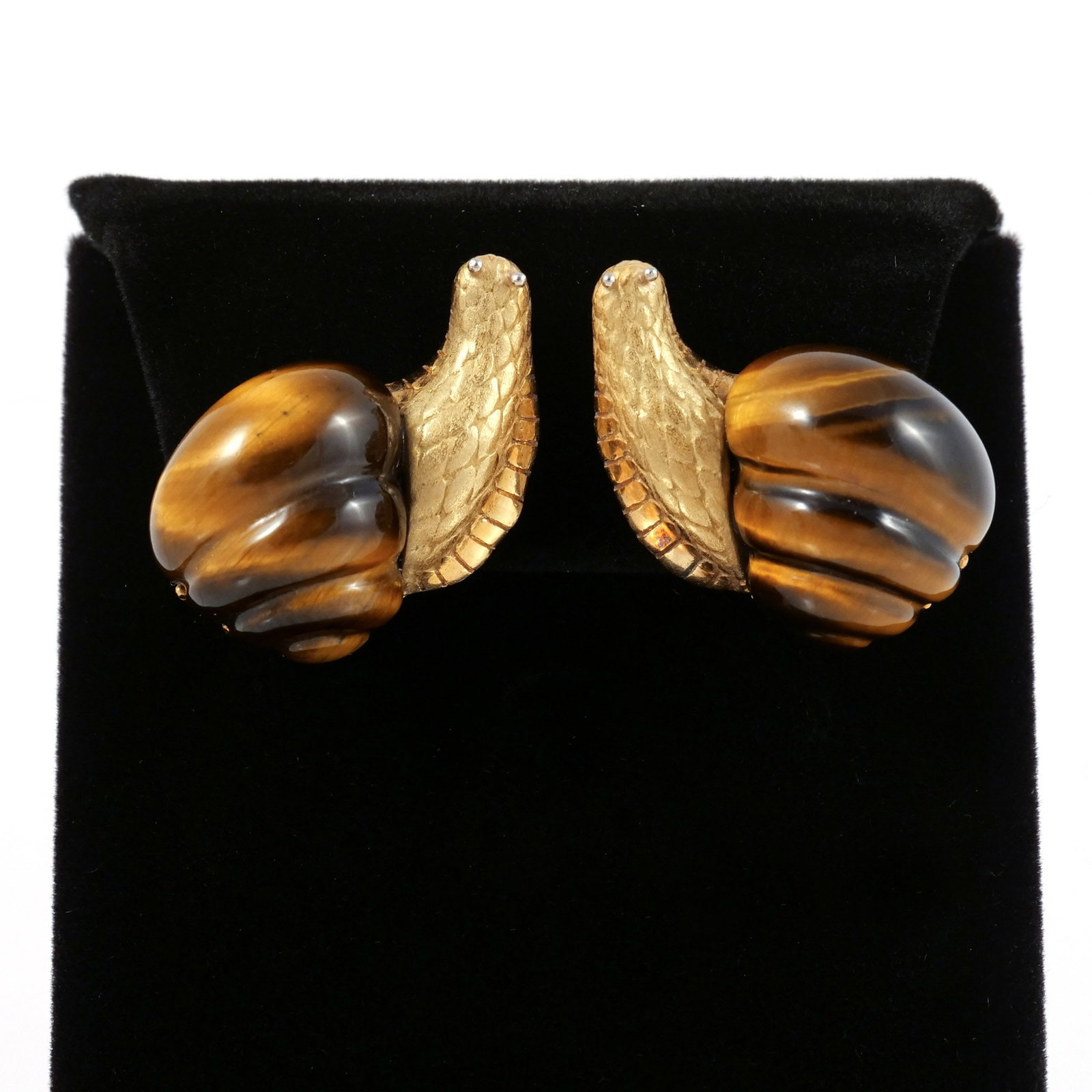 PAIR 18K GOLD & TIGER'S EYE SNAIL FORM EAR CLIPS: Each designed as a carved tiger's eye shell mounted to a textured 18K yellow gold snail body, marked 'Italy / 18K', 20 g total weightcompleted by 18K white gold omega clip backs. Signed Italy and 18K.