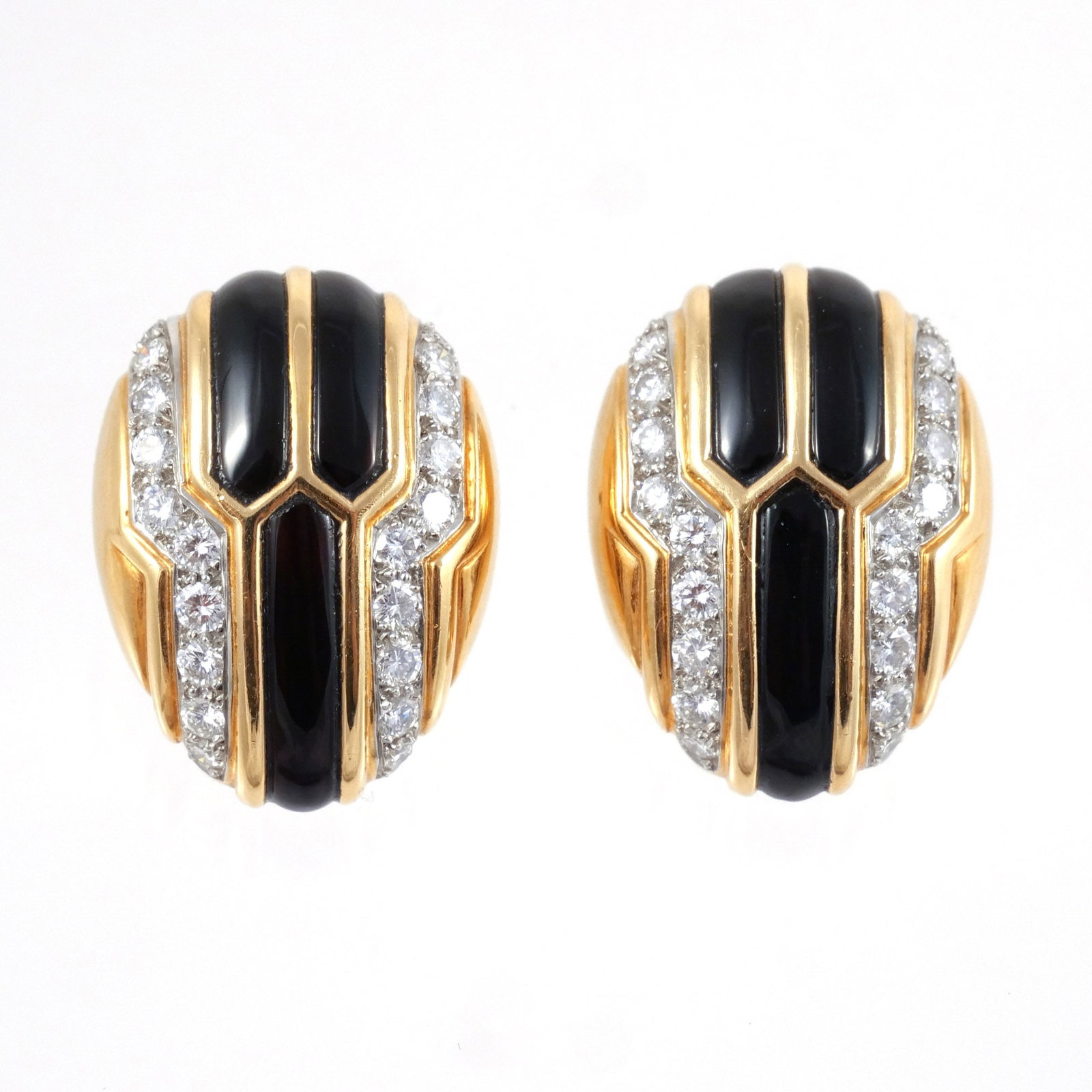 PAIR of 18K GOLD, DIAMOND, & ONYX EAR CLIPS: Of bombe oval form set with onyx panels and curved bands of round brilliant-cut diamonds, approx. 2.8 carats total diamonds, marked '18K', 26.5 g total weight h. 1 in. Provenance: Descended through th
