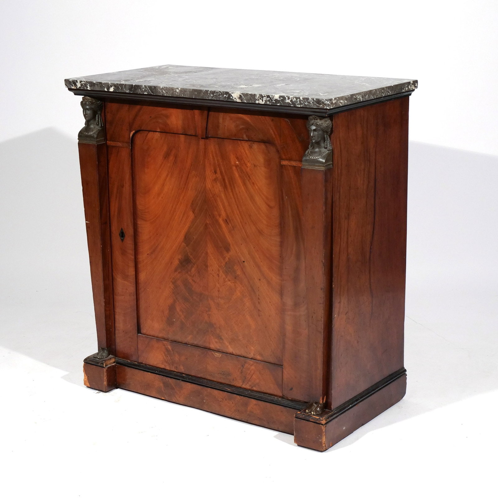 EGYPTIAN REVIVAL MAHOGANY MARBLE TOP CABINET: 19th century, with a rectangular black marble top over a single door flanked by caryatids in bronze at the head and feet, with single shelf on interior h. 33-1/4 w. 31-1/4 d. 16-5/8 in. Provenance: