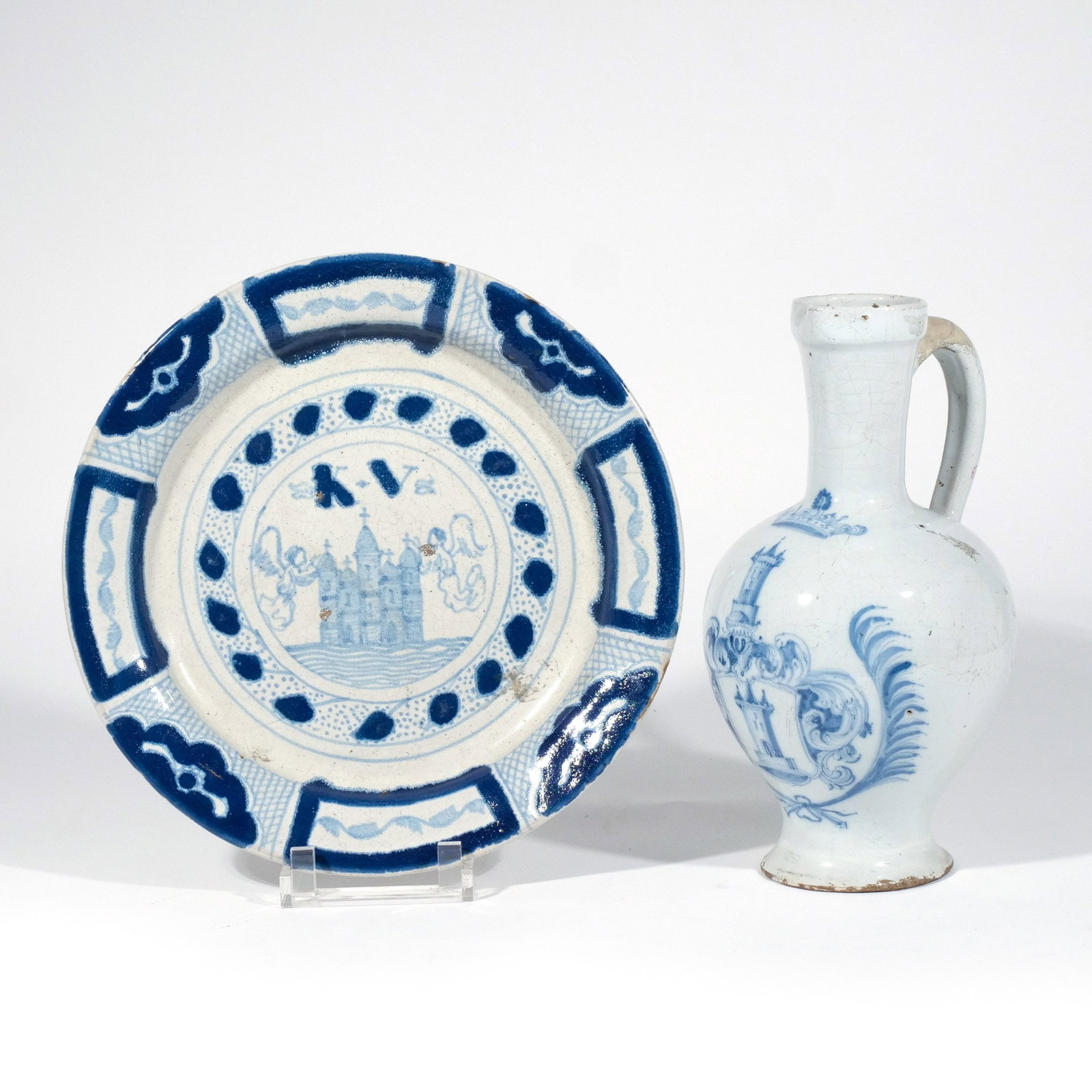 (2pc) DUTCH / CONTINENTAL CERAMICS: 19th century or earlier, including a jug and a dish with a castle beneath the initials 'K.V.', both with blue and white decoration h. 12 w. 7 in. (jug) dia. 12-7/8 in. (dish) Provenance: The estate of