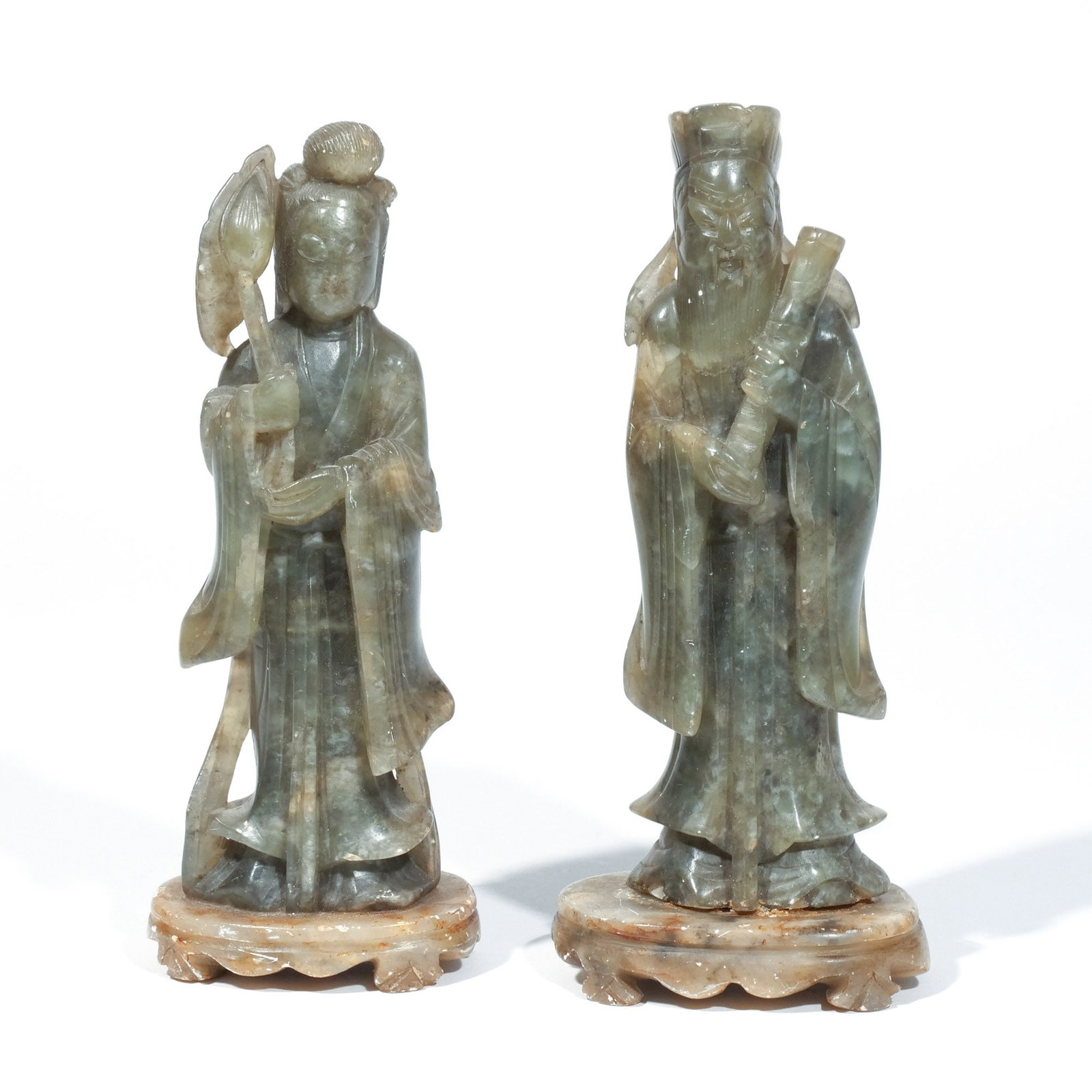 (2pc) CHINESE MOTTLED GREEN JADE CARVINGS: 20th century, including one depicting Guan Yin with a lotus sprig, and the other depicting Luxing holding a scroll, both on stands, engraved 'CHINA' under stands h. 7-3/4 w. 3-1/4 d. 2-1/4 in.