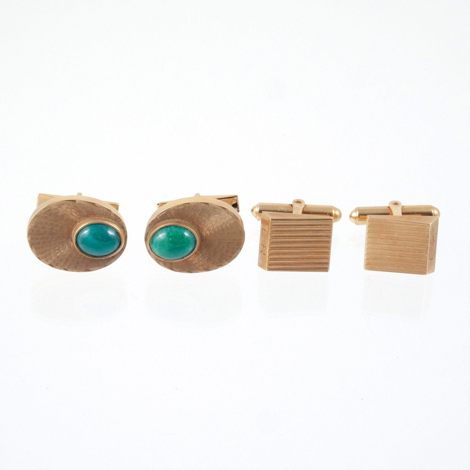 (4pc) TWO PAIRS of 14K GOLD CUFFLINKS: Including a pair of reeded gold cufflinks and a pair of textured gold cufflinks with bezel-set green cabochons stones, 26 g total weight h. 3/4 w. 5/8 in. (largest) Provenance: The estate of a noted a