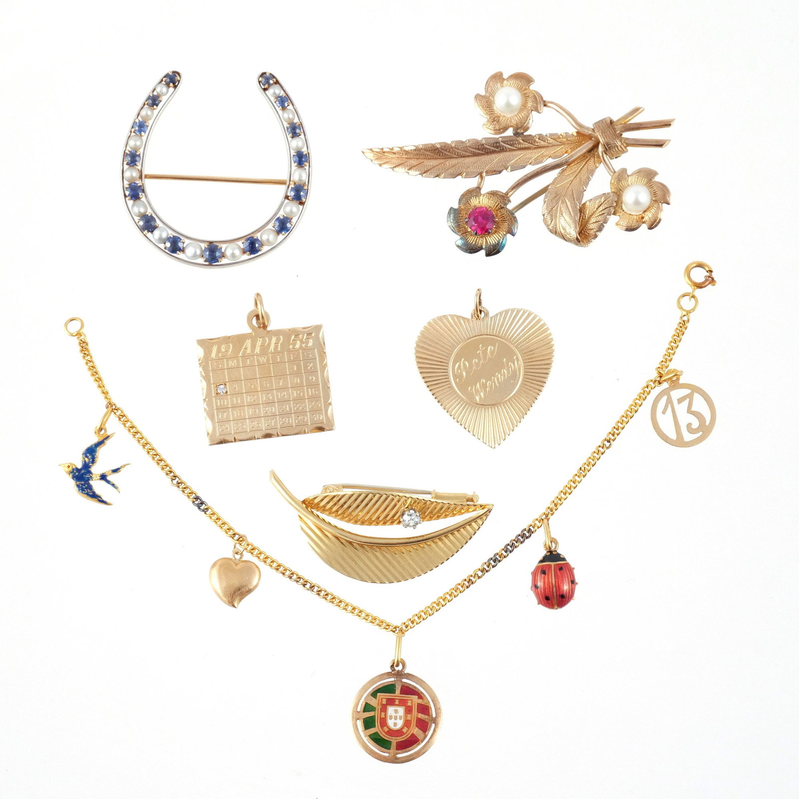 (6pc) MISC. GOLD PINS, CHARMS, AND BRACELET: Including a 19.2k charm bracelet with 5 charms, an 18k leaf pin with approx. 0.15 carat diamond, a 14k gold calendar charm with melee diamond, a 14k gold fluted heart charm, a 14k horseshoe set with b