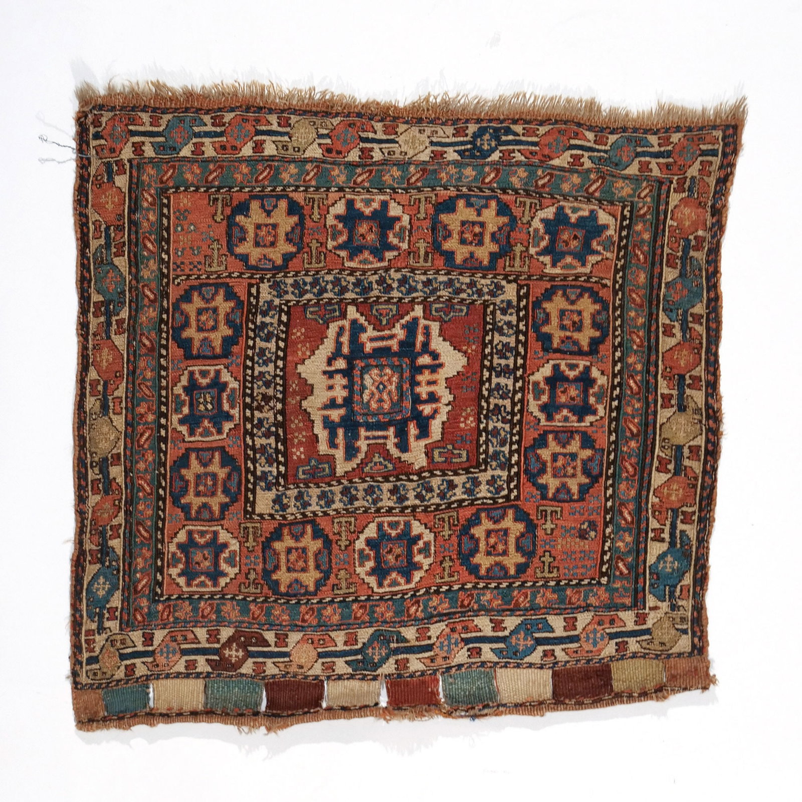SHAHSAVAN SOUMAC BAG FACE: Late 19th / early 20th century, with a single gul surrounded by a border of multicolored guls on a red ground h. 1 ft. 11 in. w. 1 ft. 11 in. Provenance: Private collection, Bernardsville, NJ