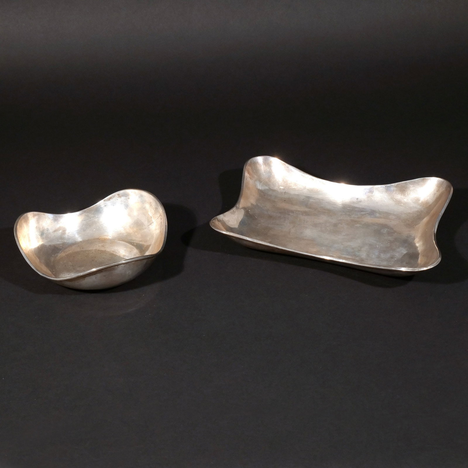 (2pc) MEXICAN STERLING SILVER TRAYS: Including a rectangular tray with maker's mark 'CLS' and a circular tray marked 'Taxco Perlita'; 26 ozt total weight h. 2-1/4 in. (tallest) w. 12 d. 8-1/4 in. (largest) Provenance: The estate of