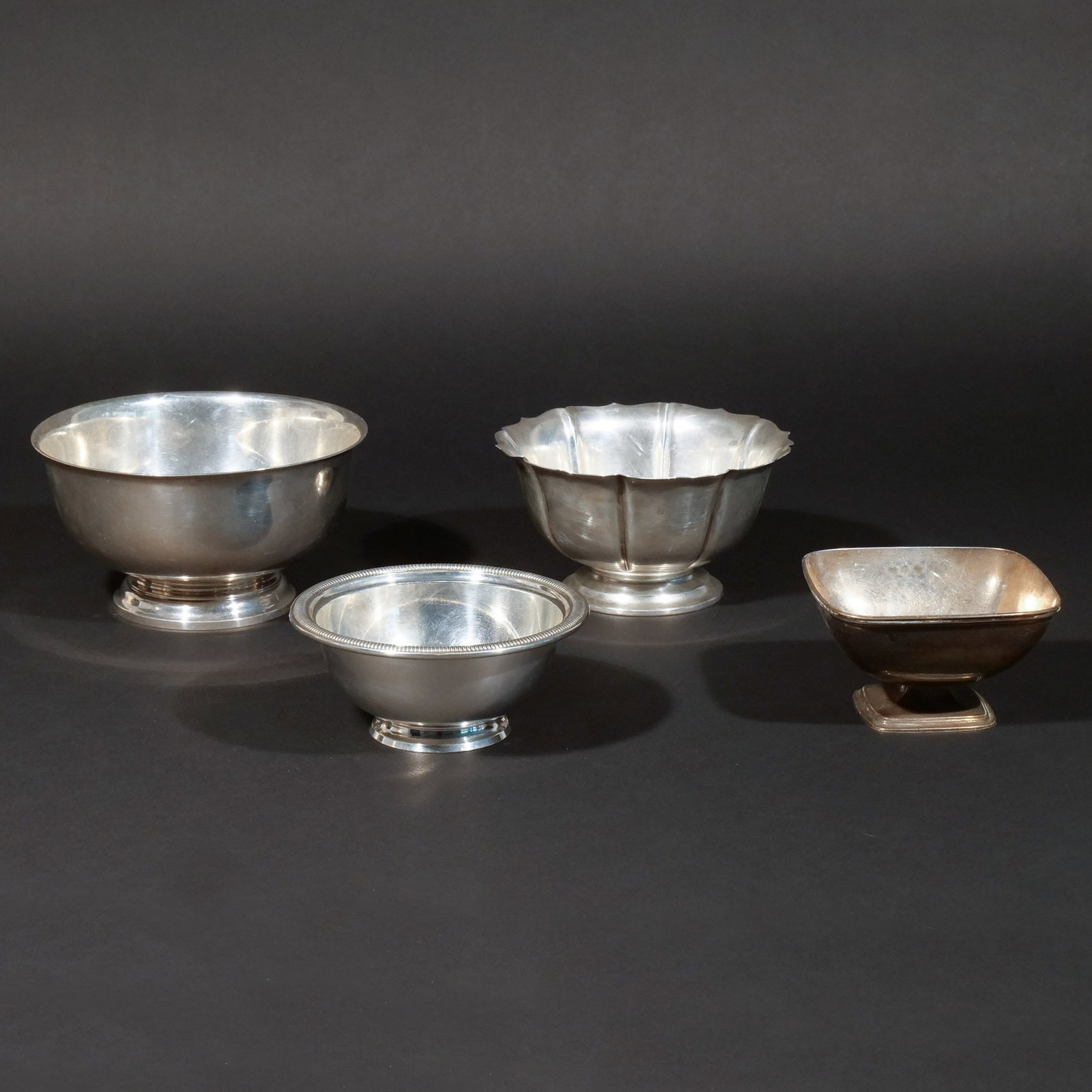 (4pc) STERLING SILVER FOOTED BOWLS: Including a Gorham Paul Revere-style bowl, a lobed bowl, a Gorham bowl with ribbed borders, and a square footed bowl; 29 ozt total weight h. 3-1/2 in. (largest) dia. 6-1/2 in. (largest) Provenance: