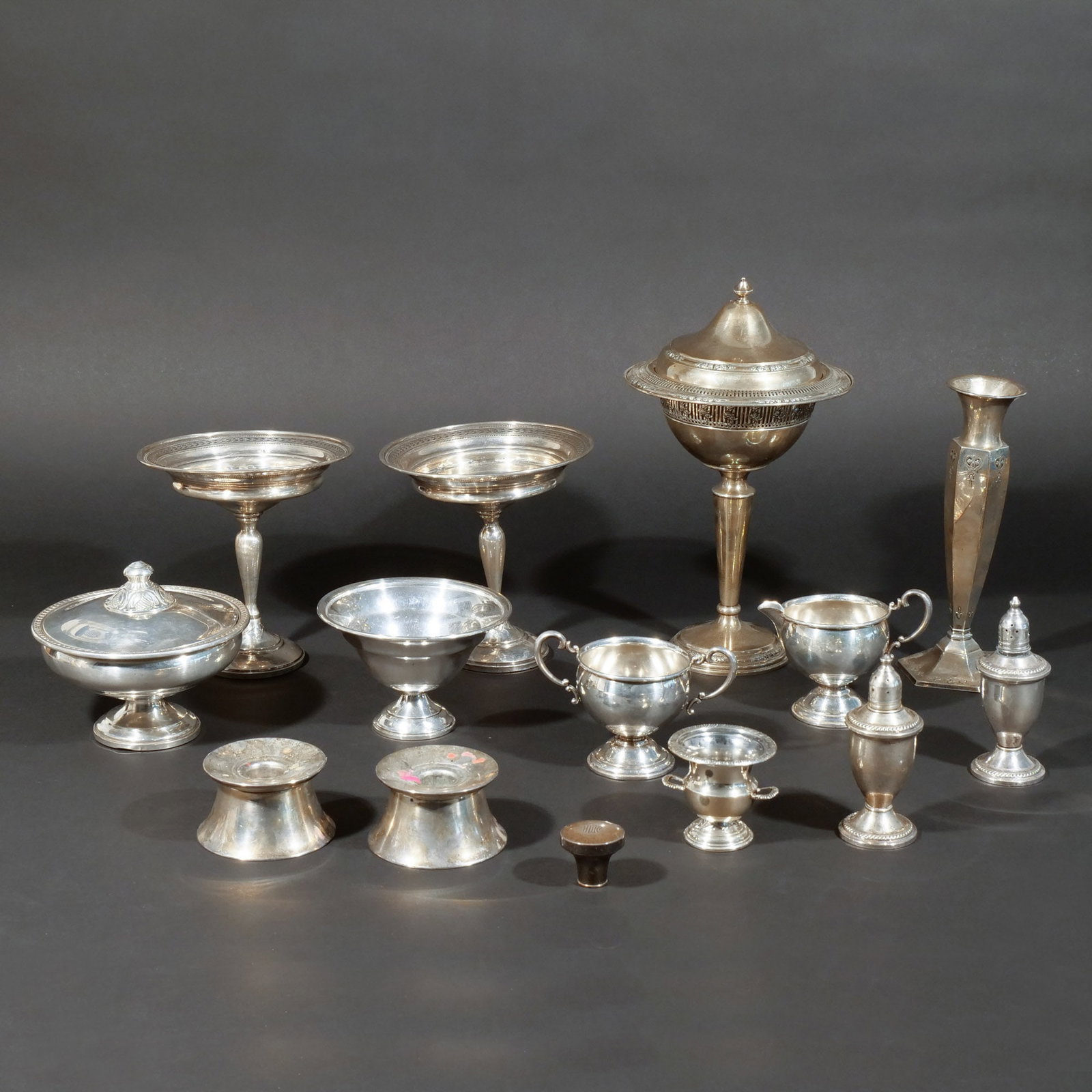 (14pc) WEIGHTED STERLING SILVER HOLLOWARE: Including 1 tall covered candy dish, a pair of compotes, 1 low-form covered candy dish, 1 footed open bowl, 1 creamer, 1 sugar, 1 egg cup, a pair of salt & pepper shakers, 1 tall candlestick, a pair o