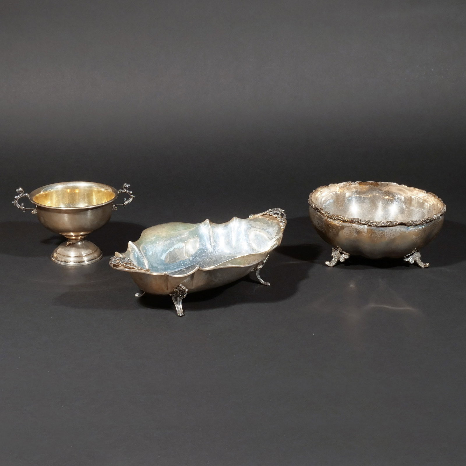 (3pc) MISC. SILVER HOLLOWARE: Including a Peruvian sterling silver shaped oval footed dish, a Mexican sterling silver lobed footed bowl, and a Reed & Barton double-handle footed cup; 30 ozt total weight h. 4 w. 11 d. 7-1/4 in. (la