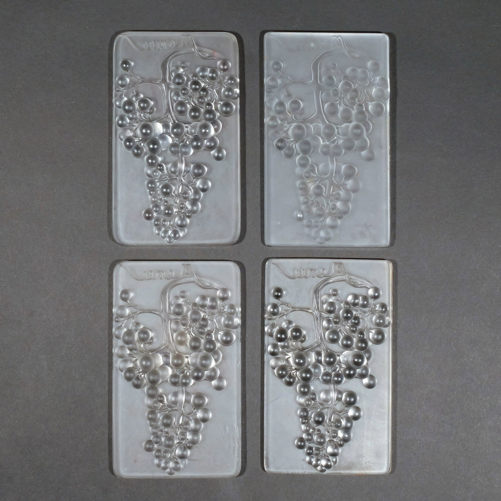 (4pc) RENE LALIQUE 'RAISIN MUSCAT' FROSTED MENUS: Of rectangular shape with rounded edges and clusters of raised and molded grapes and vines, signed 'R. Lalique / France' and with model number 3475 h. 5-3/4 w. 3-1/2 in. Provenance: The estate of
