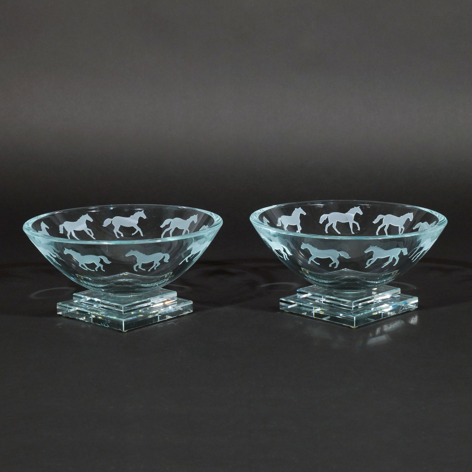 PAIR of STEPHEN SCHLANSER ART GLASS BOWLS: With galloping horse motif, signed and dated 1994 h. 4 in. dia. 8 in. Provenance: Private collection, Mount Kisco, NY [In Situ Item] This item will not be on display in our saleroom during our