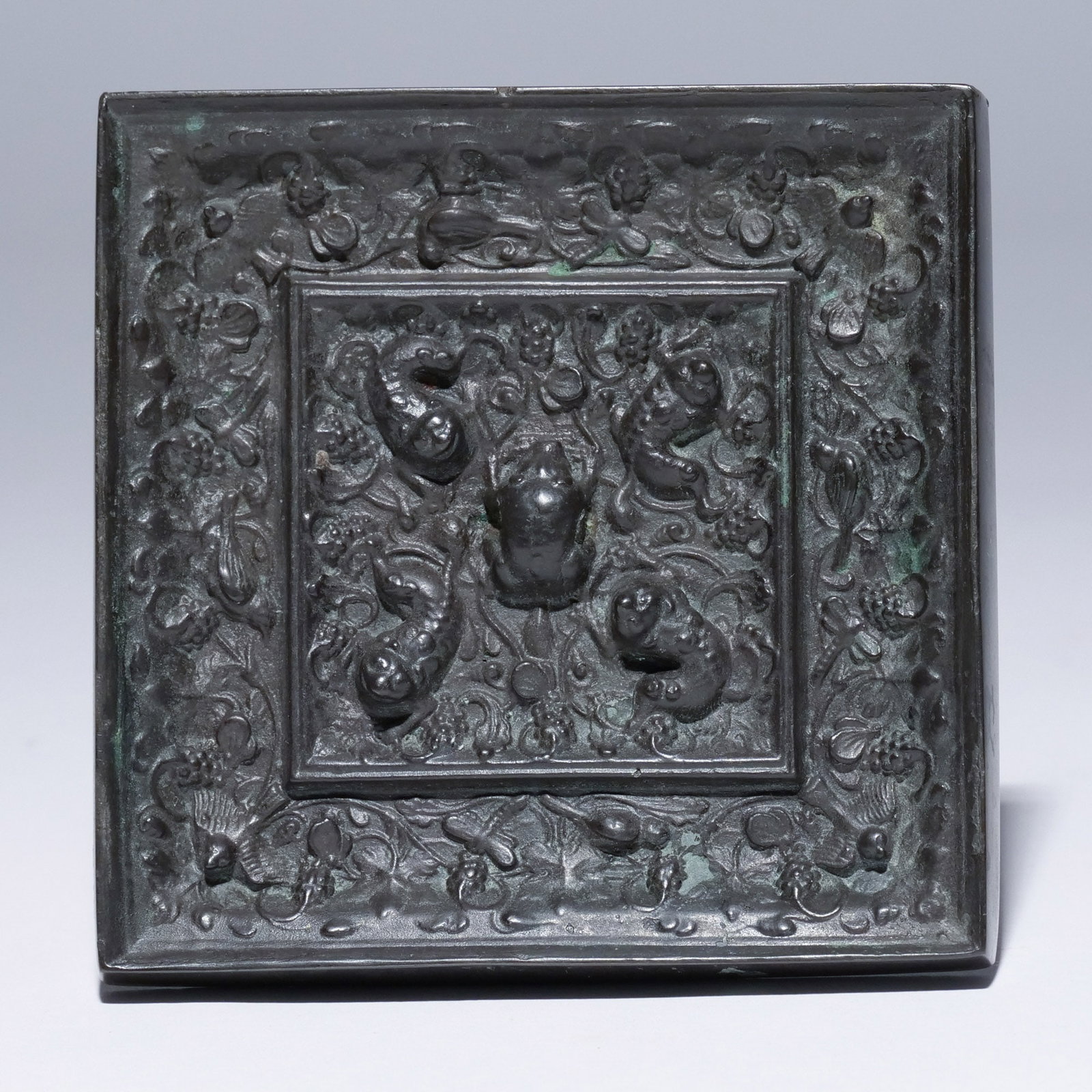 CHINESE TANG-STYLE BRONZE SQUARE MIRROR: In a Toad & Grapeleaf pattern, cast in high relief with four tadpoles shown amidst grapevine surrounding frog (unpierced), and separated by a square border from the birds, dragonflies and butterflies 