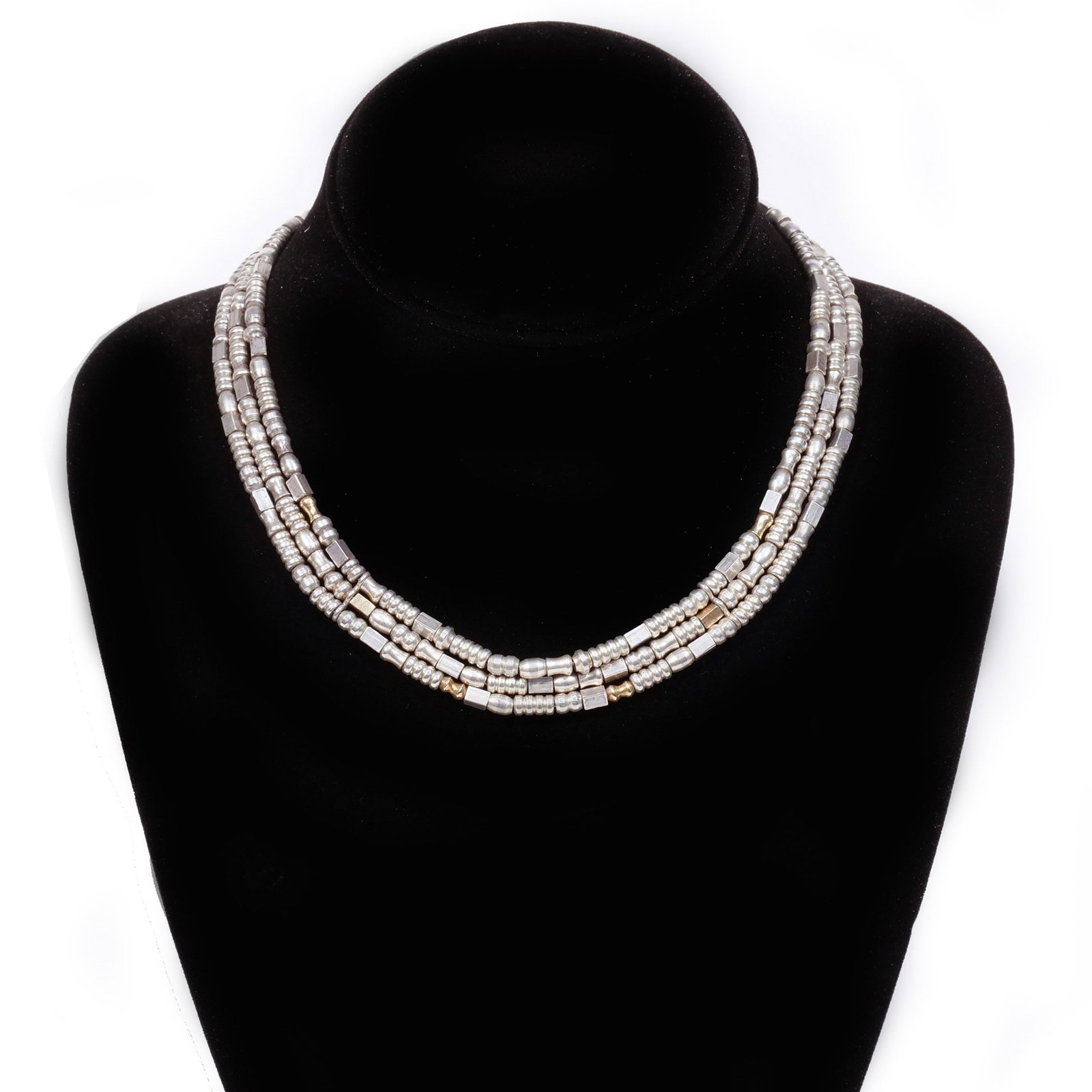 MANFREDI STERLING SILVER AND 18K GOLD NECKLACE: Choker style, composed of three strands of geometric-shaped beads in sterling silver interspersed with six 18k gold beads on a link chain, signed 'Manfredi' and marked '925' and '750', with original p