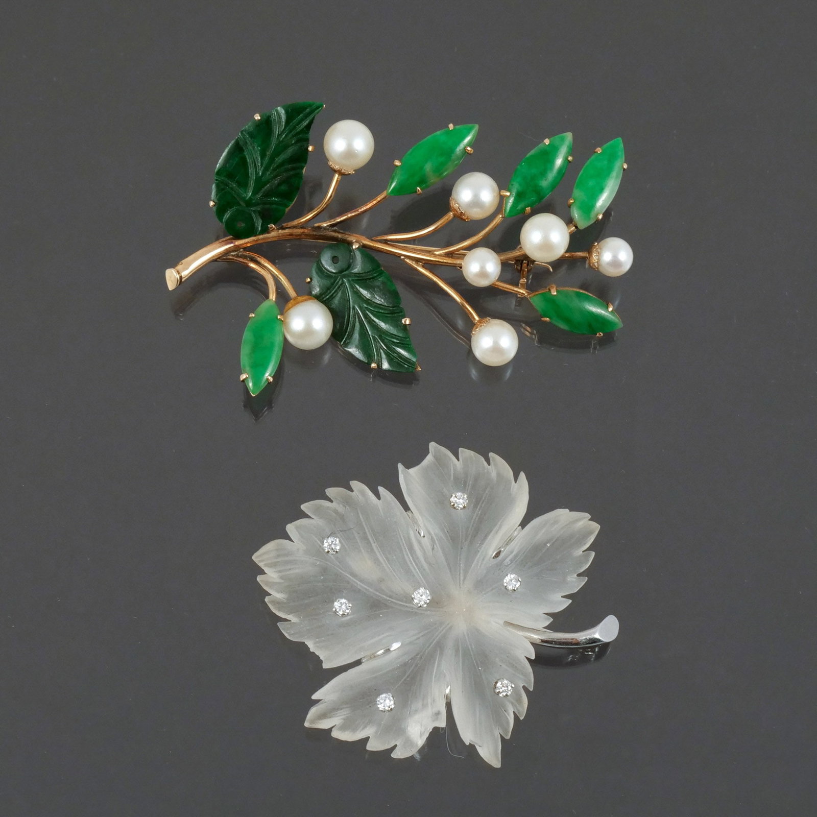 (2pc) 14K GOLD LEAF-FORM BROOCHES: Including one with jade leaves and pearl berries, and one with a rock crystal leaf with melee diamonds and white gold stem h. 2-1/4 in. (longest) Provenance: Descent through the family of the current 