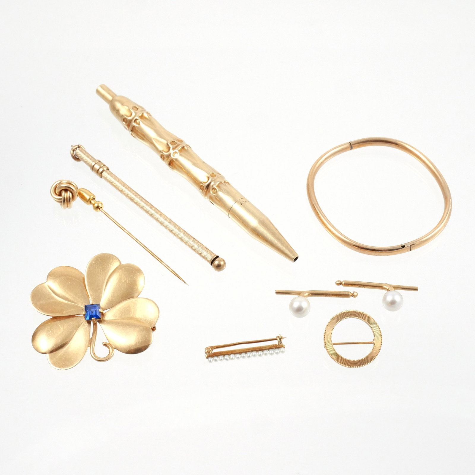 (9pc) MISC. 14K GOLD JEWELRY AND OTHER: Including a circle pin, a clover brooch with blue gemstone, a pair of pearl studs, a bar pin with seed pearls, a knot stick pin, a child's hinged bangle, and a stirrer, plus a pen with 14k gold exteri