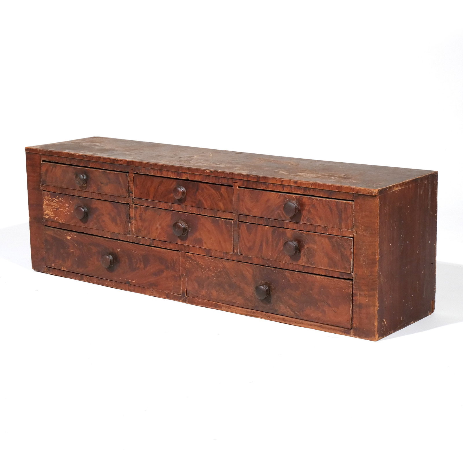 GRAIN-PAINTED TABLE-TOP APOTHECARY CHEST: 19th century, American, with two rows of three short drawers over a row of two short drawers h. 11 w. 34-1/2 d. 8-3/4 in. Provenance: Private collection, Bernardsville, NJ [In Situ Item] This item
