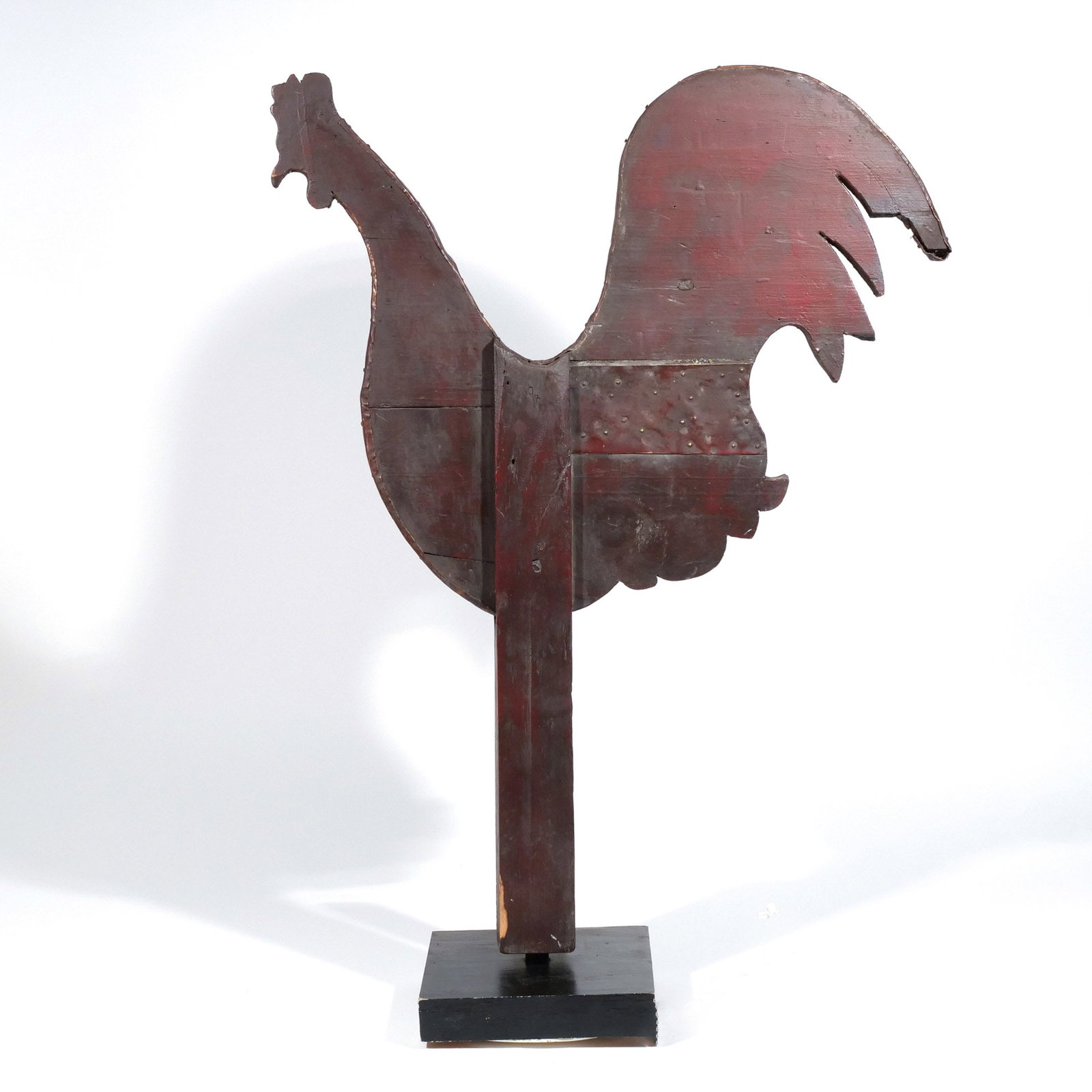 AMERICAN PAINTED & CARVED WOOD ROOSTER WEATHERVANE: 19th century, a rooster silhouette carved from two planks and painted red, with metal bindings / repairs, mounted on a post h. 31 w. 23-3/4 in. overall: 33-1/2 x 23-3/4 in. (with stand) Provenance: