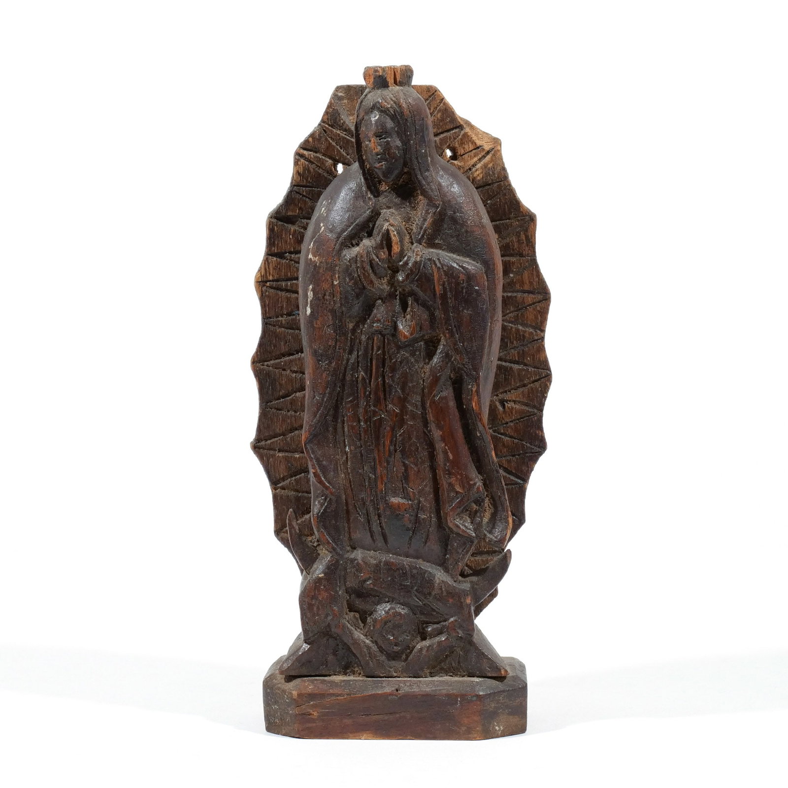 MEXICAN COLONIAL SANTOS of VIRGIN of GUADALUPE: 19th century or earlier, carved out of wood, depicting the Apparition of the Virgin of Guadalupe h. 8-3/4 w. 4 d. 2 in. Provenance: Descent through the consignor's family [In Situ Item] This item