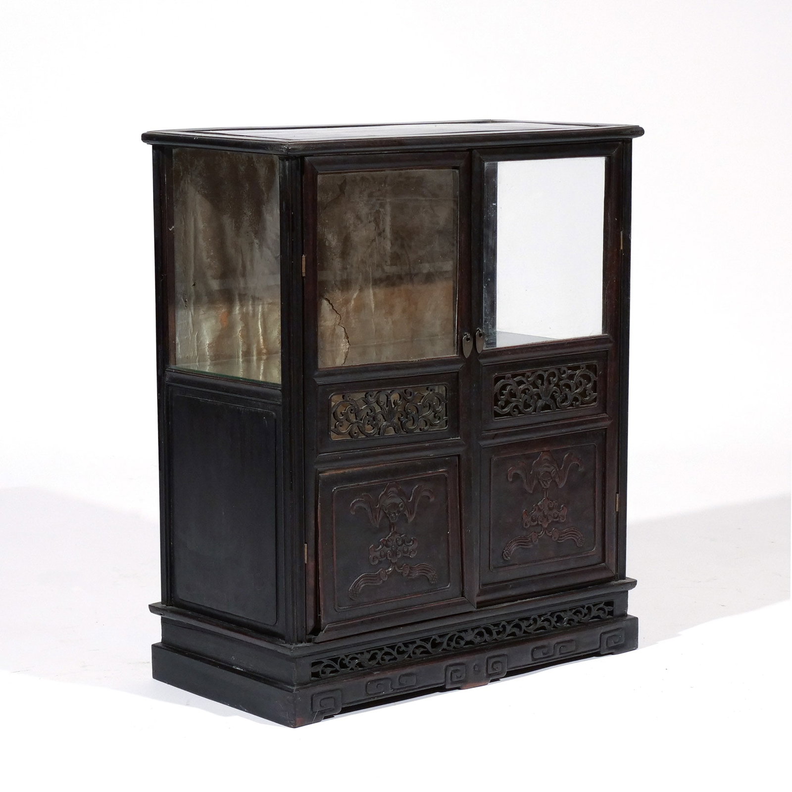 CHINESE CARVED HARDWOOD DISPLAY CABINET: Late 19th / early 20th century, possibly of Zitan wood, having partially glazed double doors h. 23 w. 19-1/2 d. 10 in. Provenance: Descent through a prominent Greenwich, CT doctor's estate [In Situ
