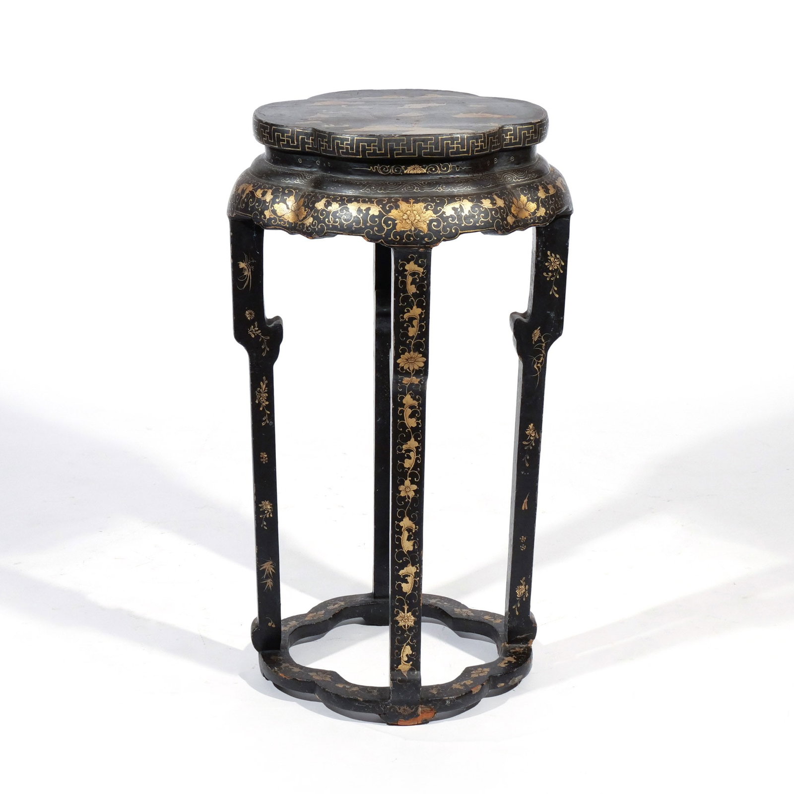 CHINESE EXPORT BLACK LACQUERED & GILT STAND: 19th century, with clover shaped top over four conforming legs joined by stretchers h. 31 w. 18 d. 17-1/2 in. Provenance: Descent through a prominent Greenwich, CT doctor's estate [In Situ Item] This