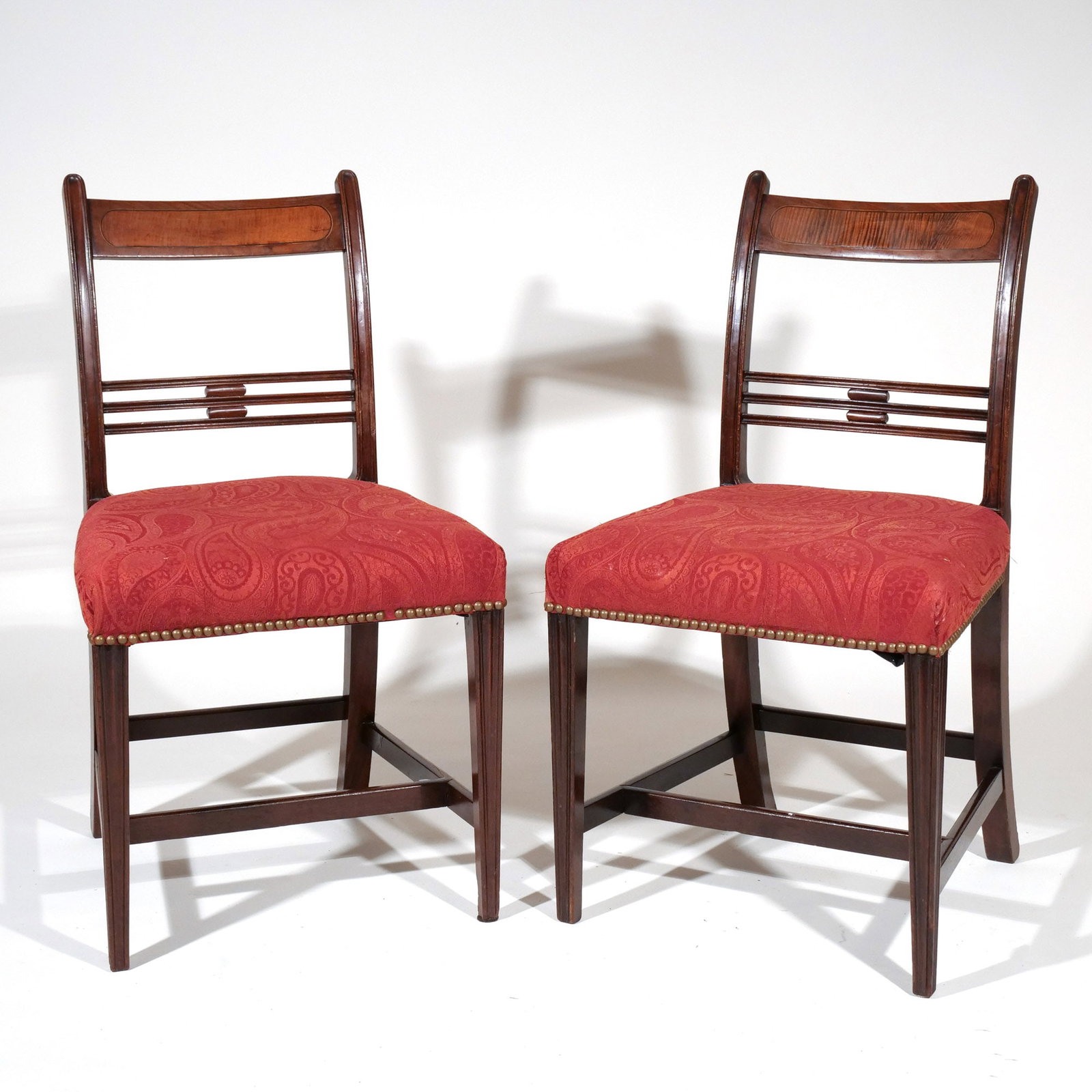 PAIR SHERATON INLAID MAHOGANY SIDE CHAIRS: Early 19th century, having figural maple crest rail, open medial splat, over upholstered seat with brass tack, sq tapering legs attached to H-stretcher h. 34 w. 18-1/2 d. 18 in. Provenance: Private