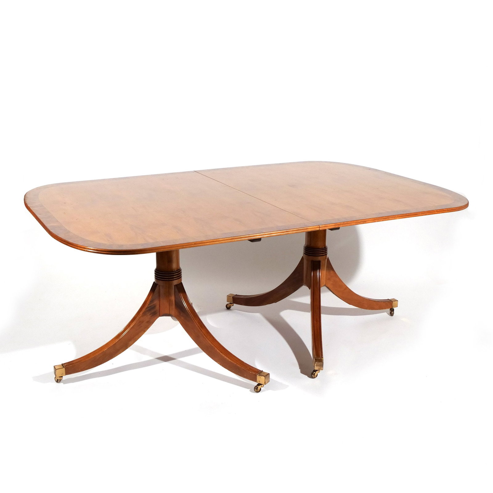 ENGLISH DOUBLE PEDESTAL DINING TABLE: Late 20th century, mahogany with banded elm and walnut top, with two leaves h. 29-1/2 w. 72-1/2 d. 47-1/2 in. Provenance: Private collection, Mount Kisco, NY [In Situ Item] This item will not be on
