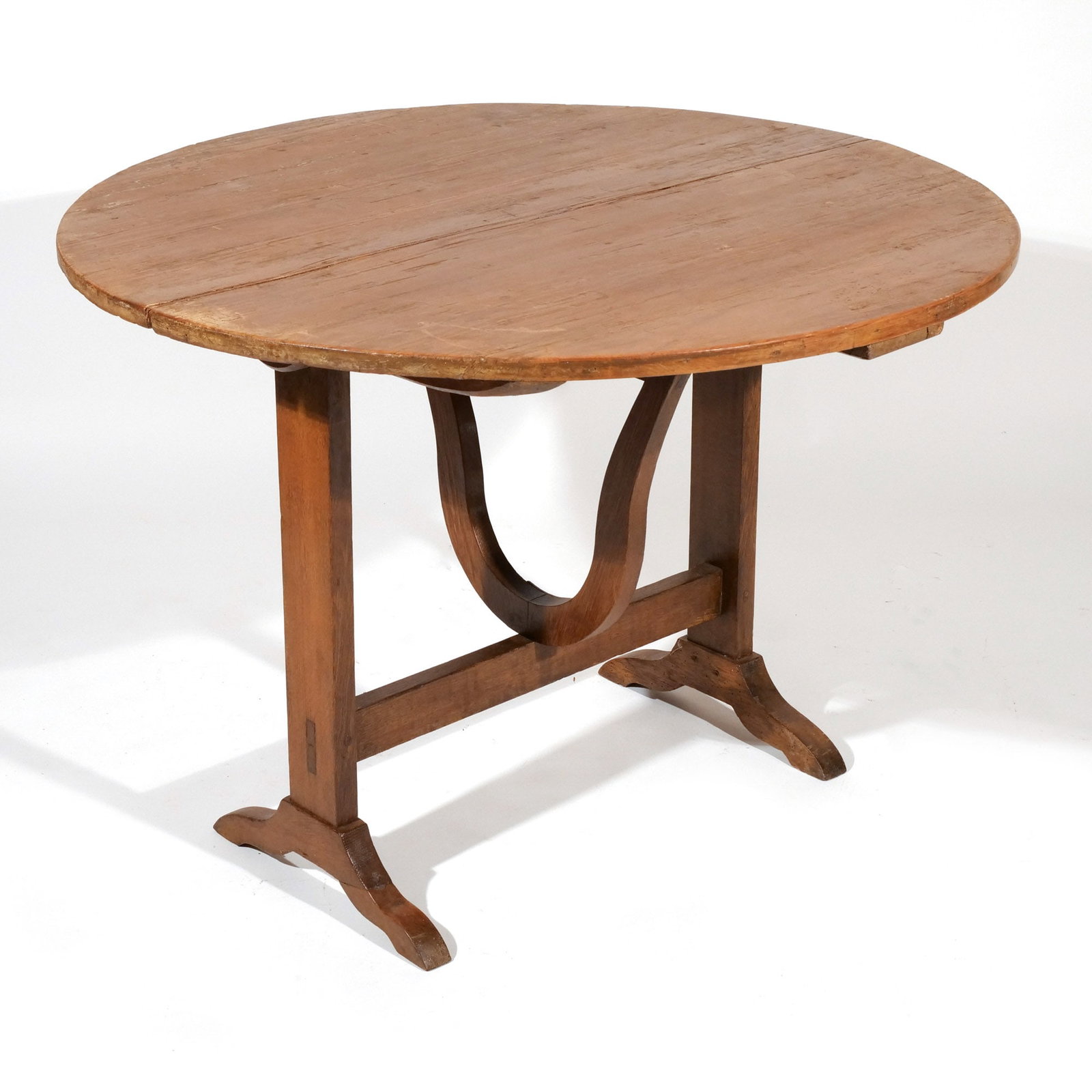 ANTIQUE PINE FLIP TOP COACHING TABLE: 19th century, with circular top, trestle base and wishbone-shaped support h. 27-1/2 w. 38-3/4 d. 37-3/4 in. Provenance: Private collection, Bernardsville, NJ [In Situ Item] This item will not be on