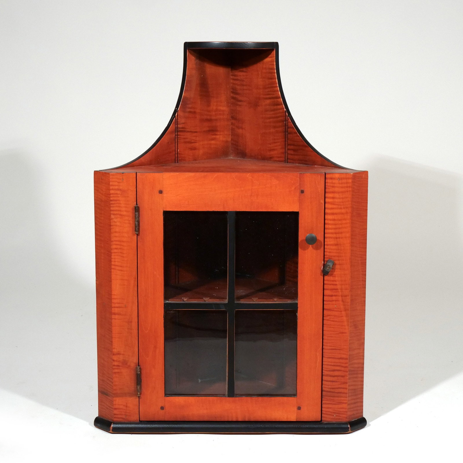 DAVID T. SMITH TIGER MAPLE HANGING CORNER CABINET: Stenciled David T. logo on back board h. 29-1/2 w. 21 d. 11 in. Provenance: Private collection, Bernardsville, NJ [In Situ Item] This item will not be on display in our saleroom during our preview