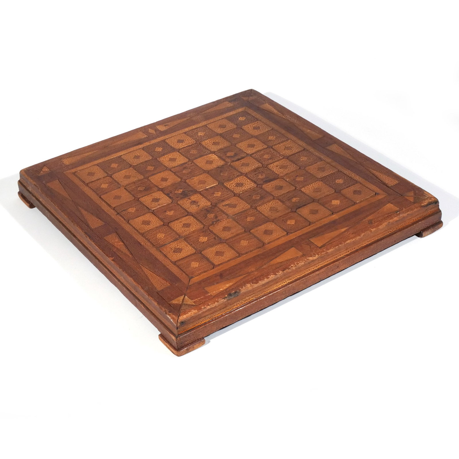 ANTIQUE PARQUETRY INLAID GAMEBOARD: Early 20th century, raised on pad feet h. 2-5/8 w. 21-1/2 d. 21-1/2 in. Provenance: Private collection, Bernardsville, NJ [In Situ Item] This item will not be on display in our saleroom during our pre