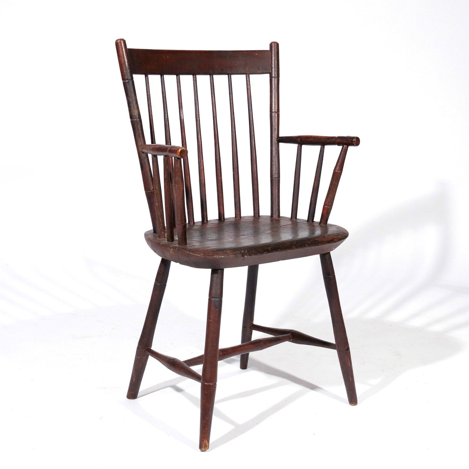 BLACK PAINTED AMER. BIRD CAGE WINDSOR ARMCHAIR: 19th century with a straight crest and turned arms and legs joined by an H stretcher h. 34 w. 21 d. 19 in. Provenance: Landmark Hoyt Homestead, Pound Ridge, NY [In Situ Item] This item will not be on
