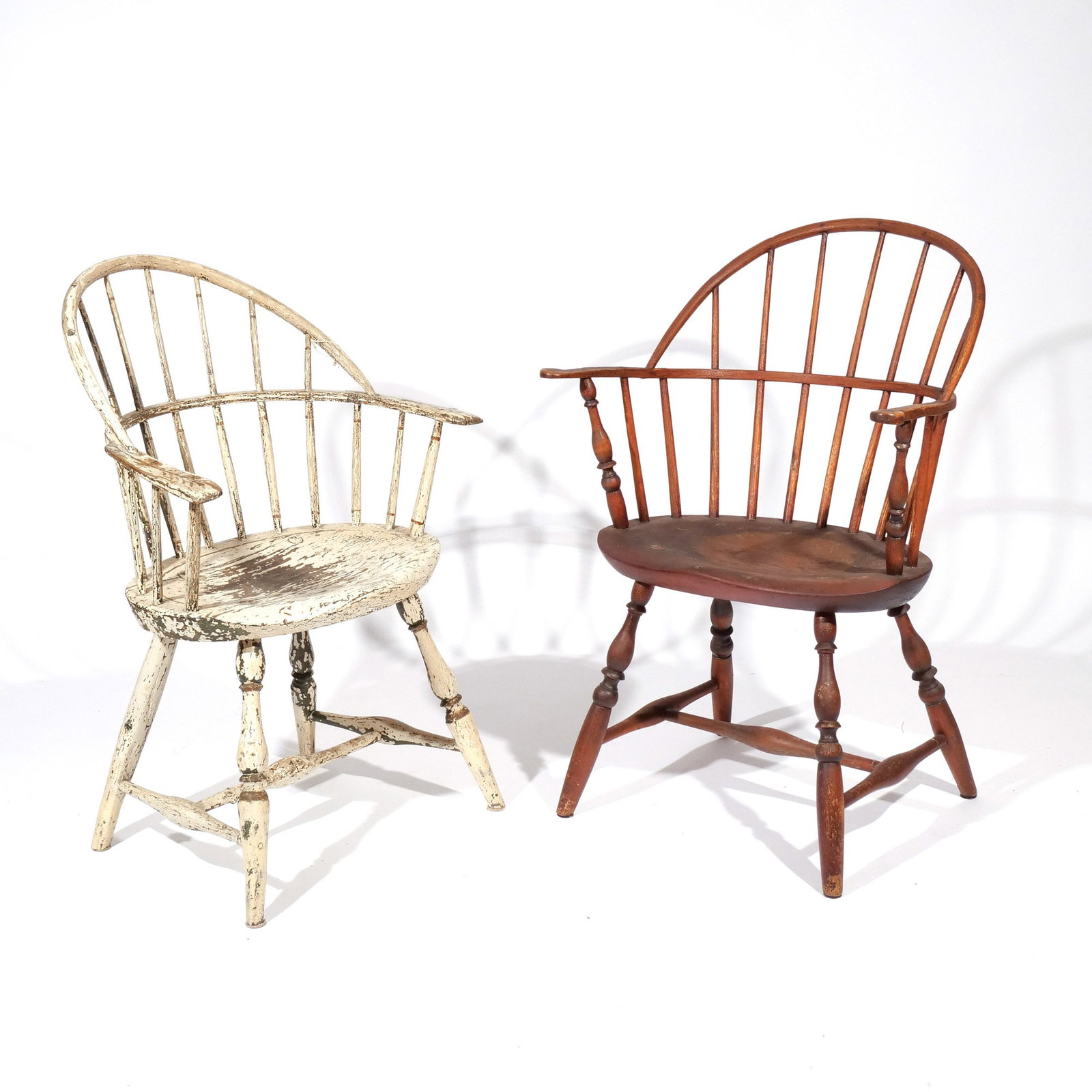 (2pc) AMERICAN SACK-BACK WINDSOR ARMCHAIRS: 19th century or earlier, including one in white paint and one in red paint h. 16-1/2 in. (seat) w. 21 d. 14 in. overall: 34-1/2 x 21 x 14 in. Provenance: Private collection, Bernardsville, NJ [In