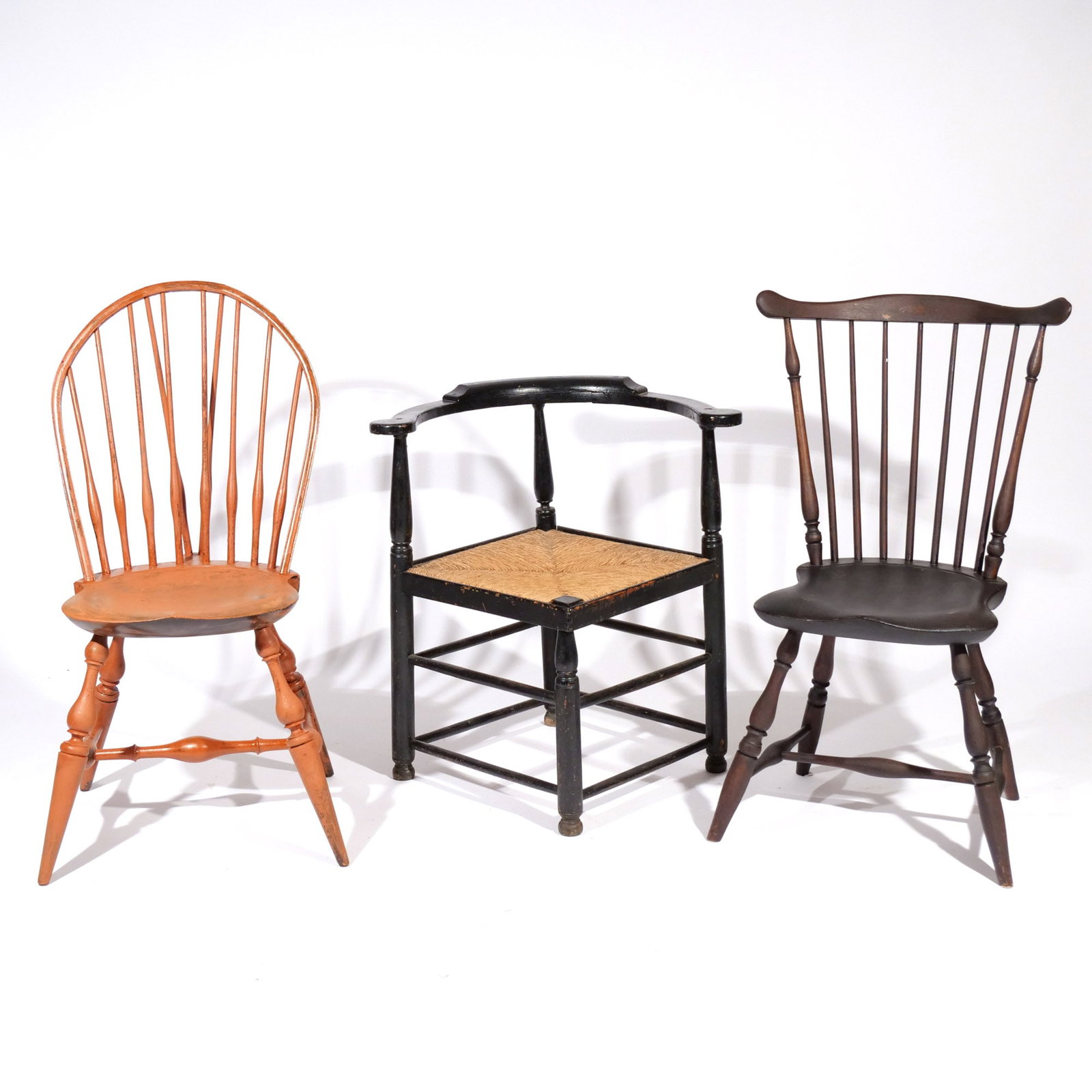 (3pc) MISC. WINDSOR CHAIRS & CORNER CHAIR: Including a 19th century corner chair in black paint with rush seat; a Wallace Nutting brace-back windsor side chair; and an early 20th century painted windsor side chair with shaped crest and seat