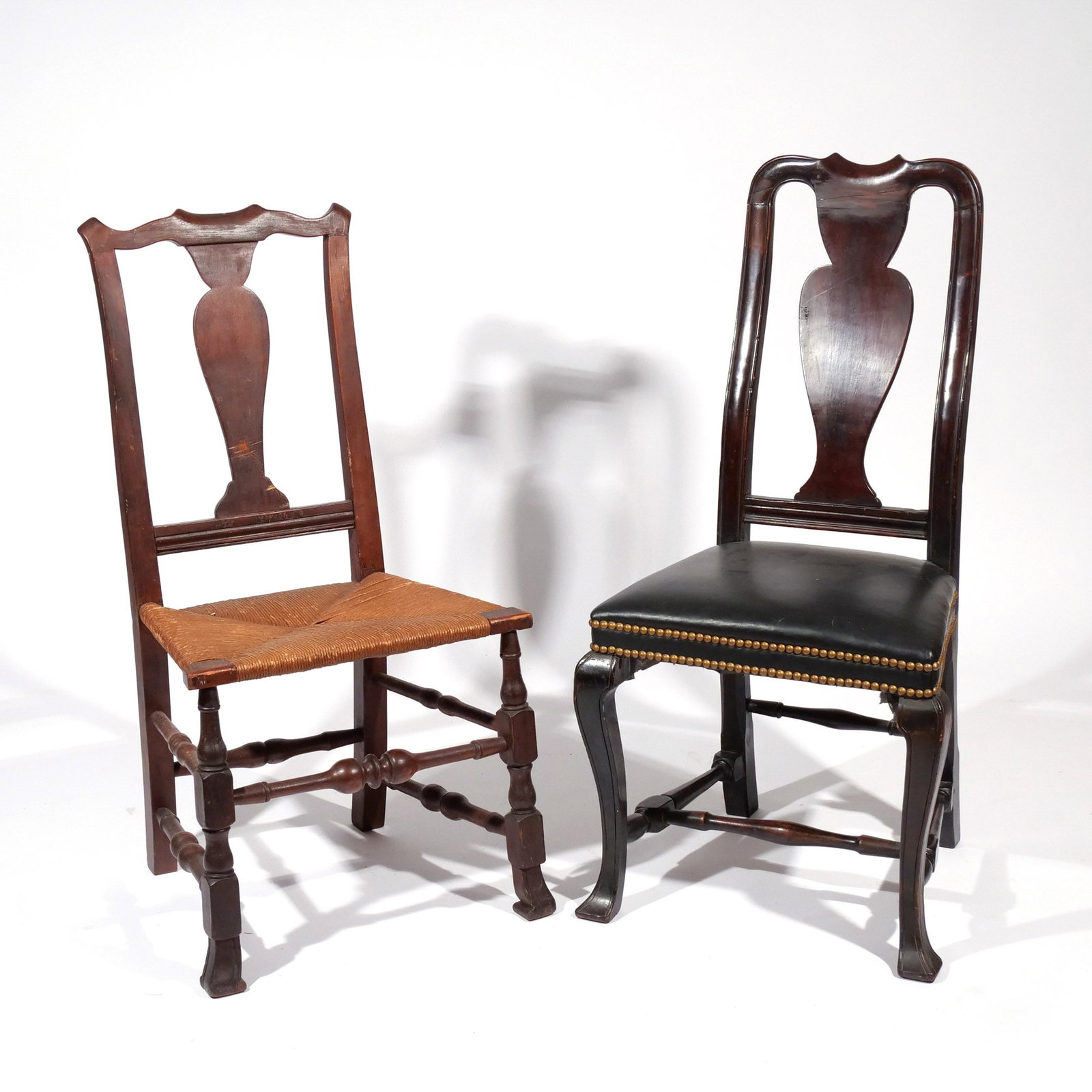 (2pc) AMERICAN QUEEN ANNE SIDE CHAIRS: 18th century, including both with vasiform splats and Spanish feet, one with rush seat and one with leather seat h. 18 in. (seat) w. 19 d. 15-1/2 in. overall: 41 x 19 x 15-1/2 in. Provenance: Private