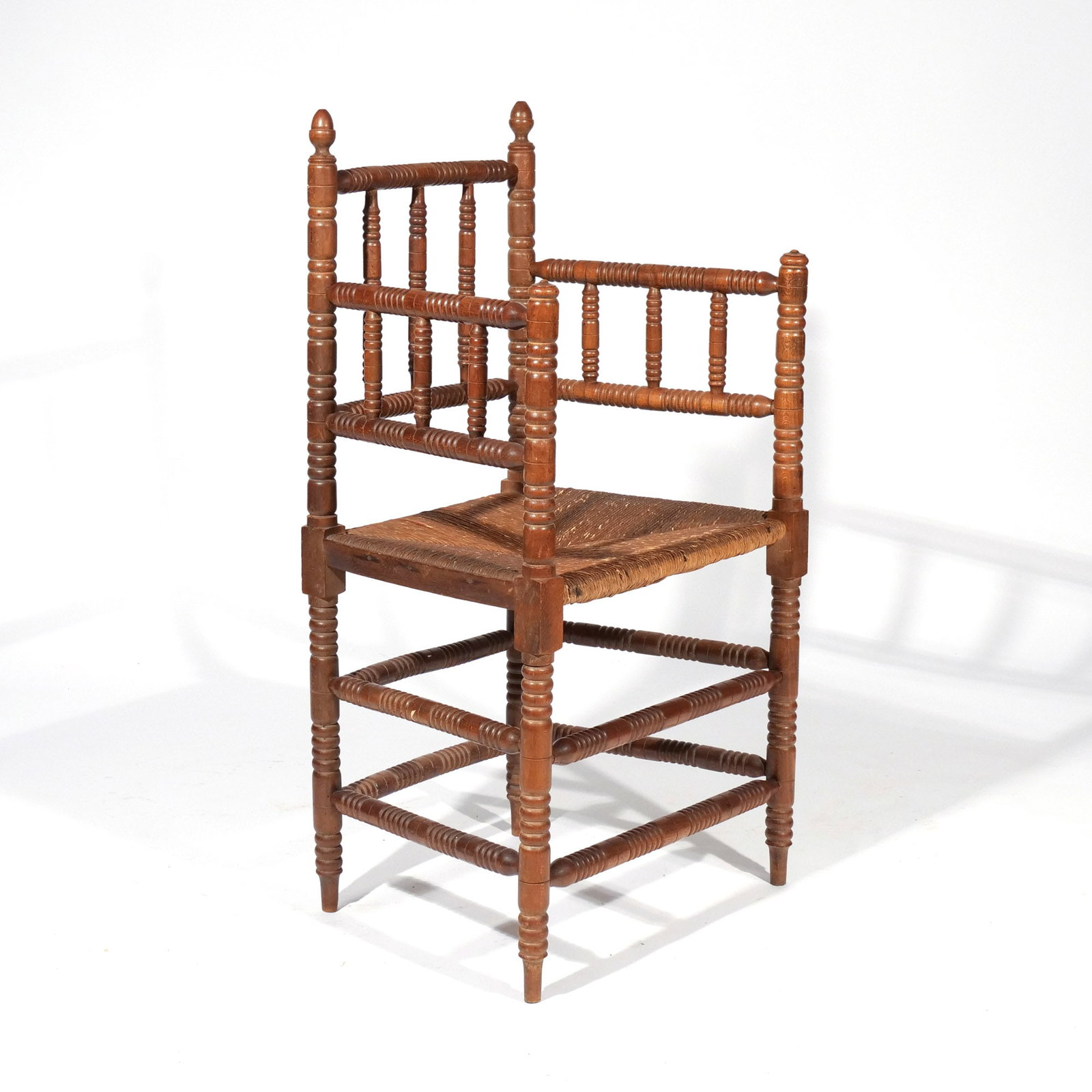 PILGRIM-STYLE ARMCHAIR: 19th century, having acorn finials, overall bobbin turnings, peg feet h. 19 in. (seat) w. 19-1/2 d. 16-1/2 in. overall: 39 x 19-1/2 x 16-1/2 in. Provenance: Landmark Hoyt Homestead, Pound Ridge, NY