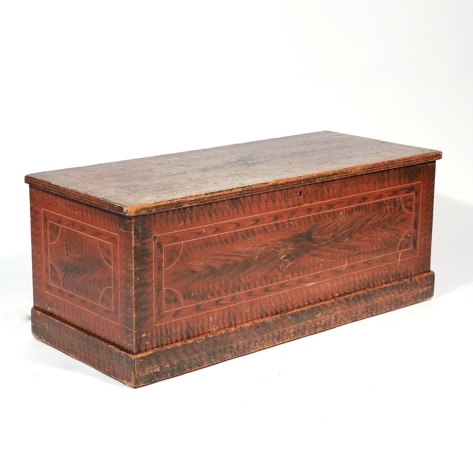 NEW ENGLAND GRAIN-PAINTED BLANKET CHEST: Early-mid 19th century, of rectangular shape with flat top, painted with rectangular line-work reserves on a red ground with black 'grain' h. 18 w. 41 d. 17-1/2 Provenance: Private collection,