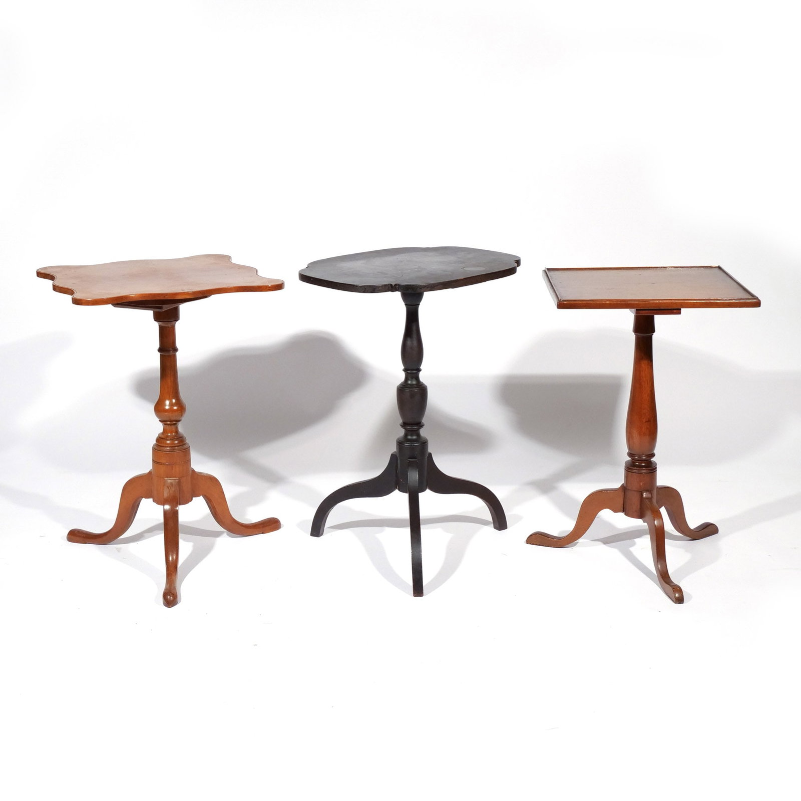 (3pc) CANDLESTANDS AND TILT-TOP TABLES: Including one tilt-top table with a shaped square top; one candlestand in black paint with a shaped rectangular top; and one candlestand with a square top h. 27 w. 18-1/2 d. 18-1/2 in. (largest)