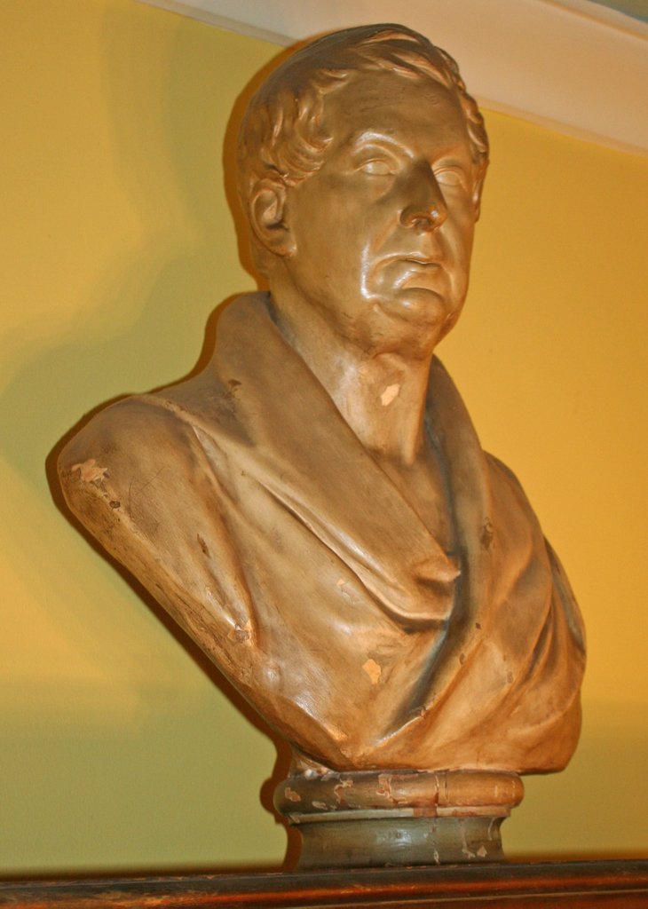 193) PLASTER BUST OF A MAN on a wooden socle, approx.: height: 26"