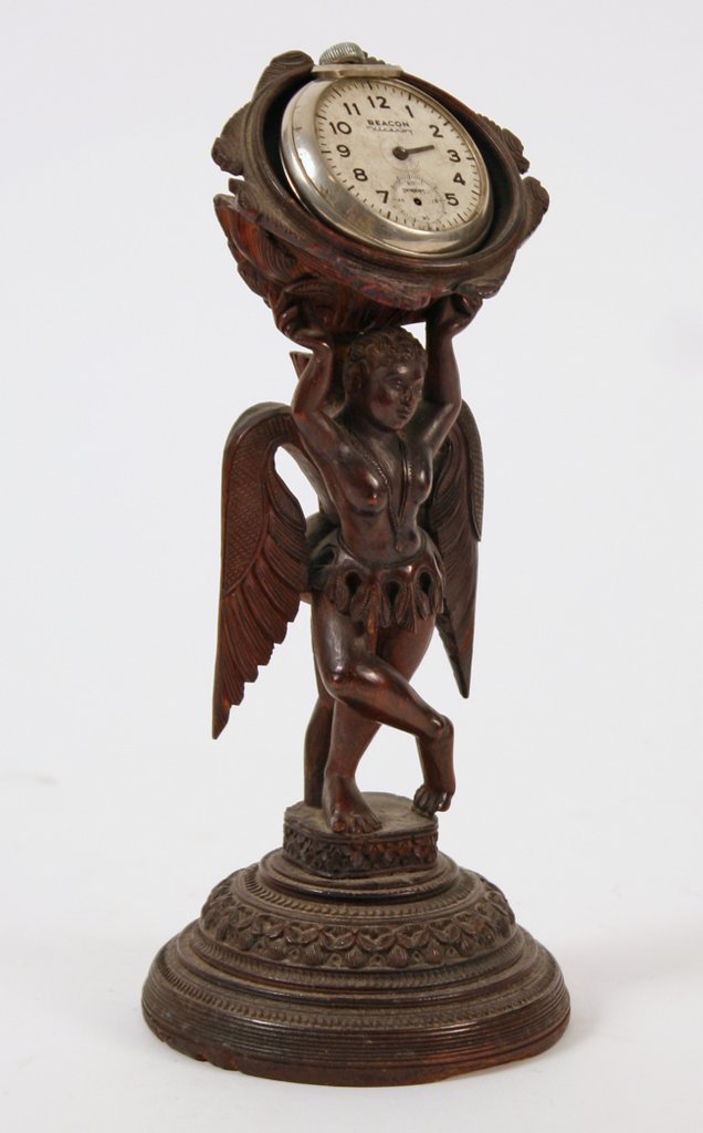 451) 19TH C. CARVED WATCH HUTCH WITH WINGED: POLYNESIAN FEMALE FIGURAL SUPPORT, RESTING ON INTRICATELY CVD. SOCLE, H: 8 ¼"