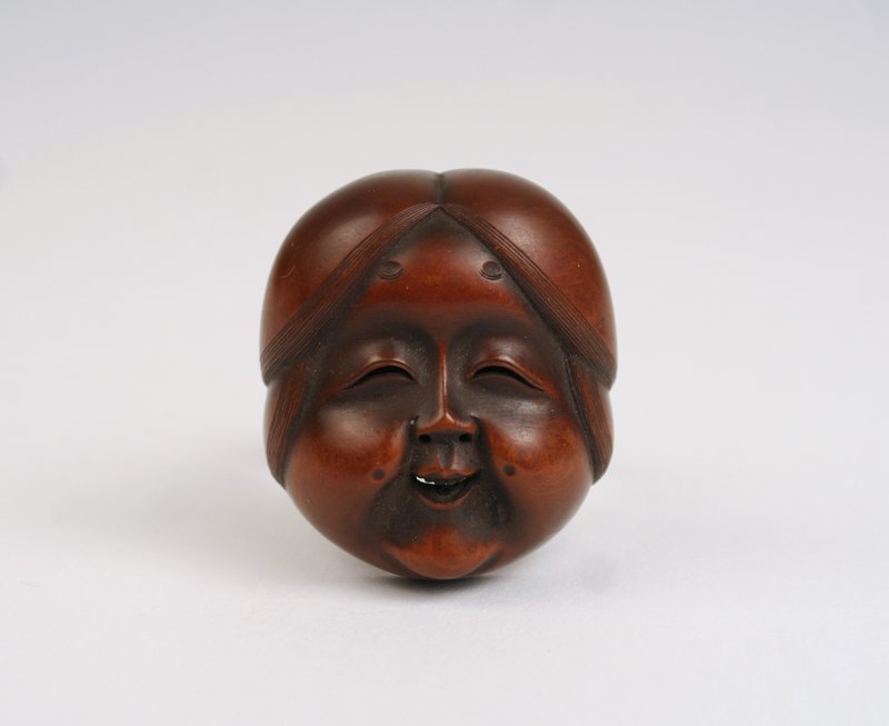 478) OKAME NETSUKE MASK, C. 1840: CARVED BOXWOOD, SGD., 1.5 X 1.75"
