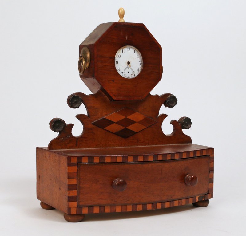 INLAID MAHOGANY STEP-BACK WATCH HUTCH: 19th Century, the octagonal head above a shaped superstructure with carved rosettes centered by an inlaid diamond above a full drawer, h. 9 ½" w. 8" d. 4 ¼"