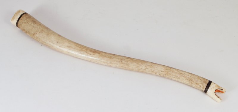 ANTIQUE CARVED INUIT POLYCHROMED BONE & TUSK WAND,: terminating in a walrus' head at one side and a polar bear's at the other, L. 21 ½"