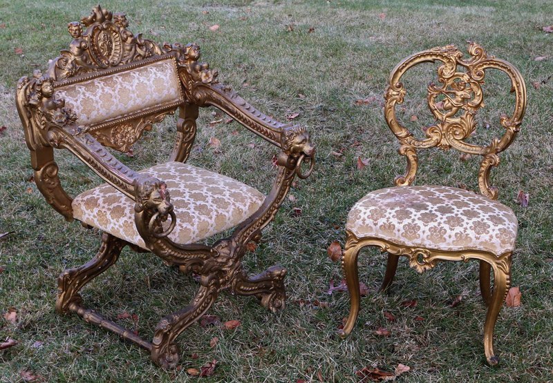2-NEO-CLASSICAL CHAIRS: CURULE-FORM GILT THRONE CHAIR,: crested by a cartouche centered with a heraldry device flanked by seated Hermes and Herm finials, arm terminal with lion's heads and loose rings, upholstered seat and medial backrest, H. 38", W. 22", 